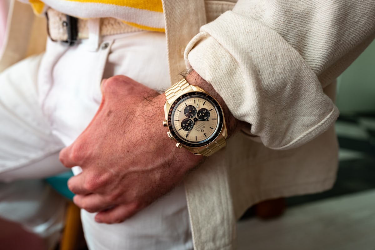 The gold dial speedmaster moonshine on a man's wrist. 