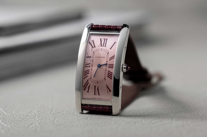 Wei Koh's special order Cartier Tank Cintrée in platinum with burgundy Roman numerals and pink-ish dial.