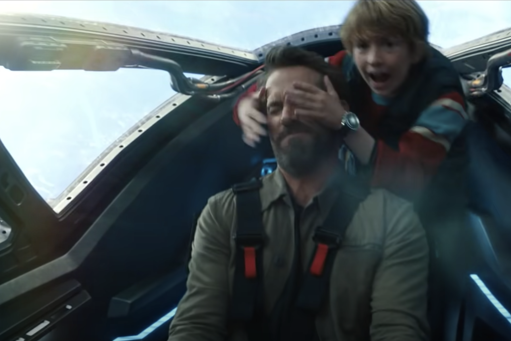 Young Adam going wild in the cockpit of his older self's Time Fighter wearing his large Speedmaster in The Adam Project.