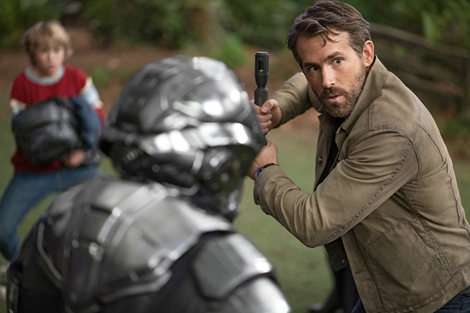 Big Adam (Reynolds) wielding his non-lightsaber lightsaber while wearing his Speedmaster in The Adam Project