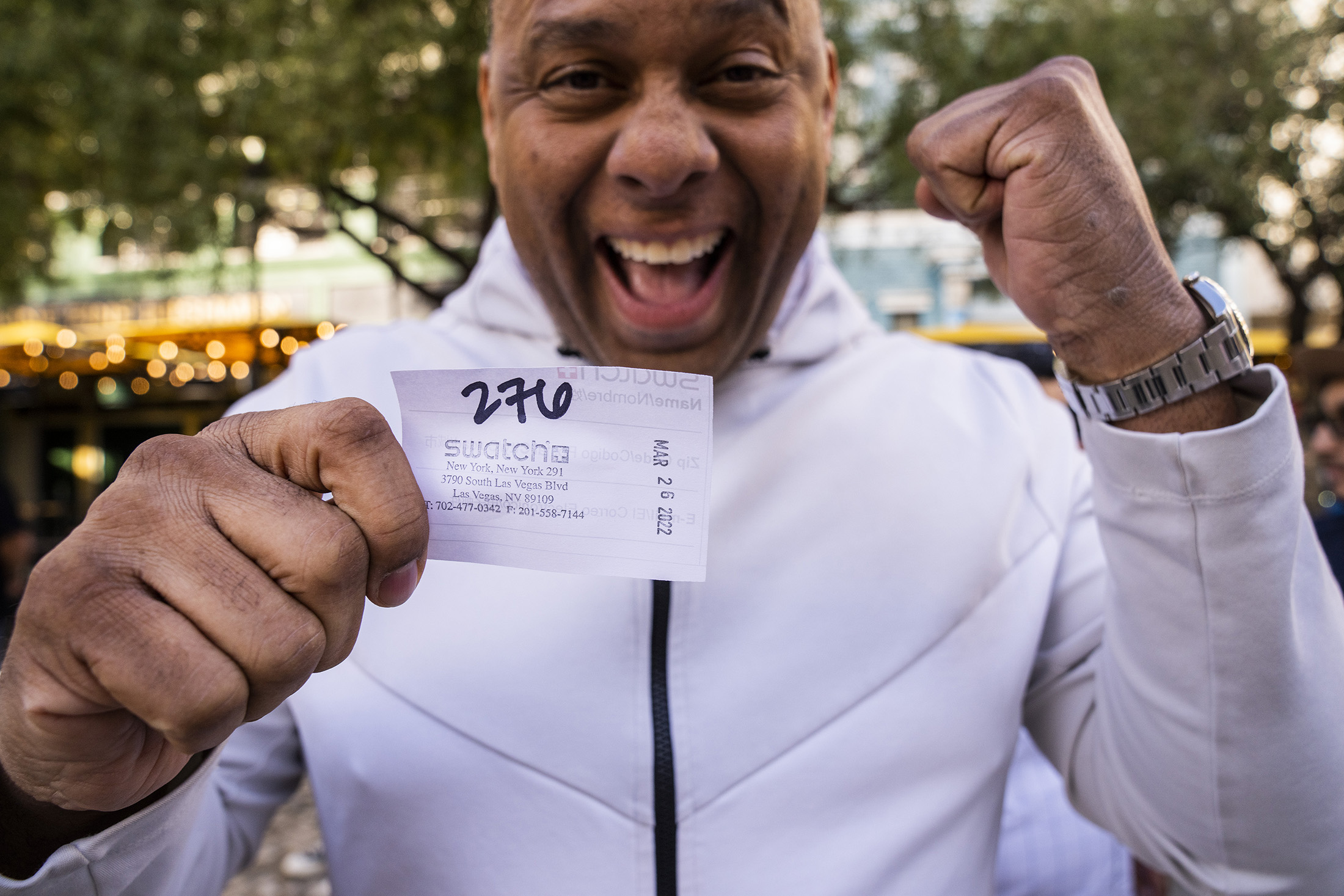 a customer awaits with their ticket to buy a Moonswatch