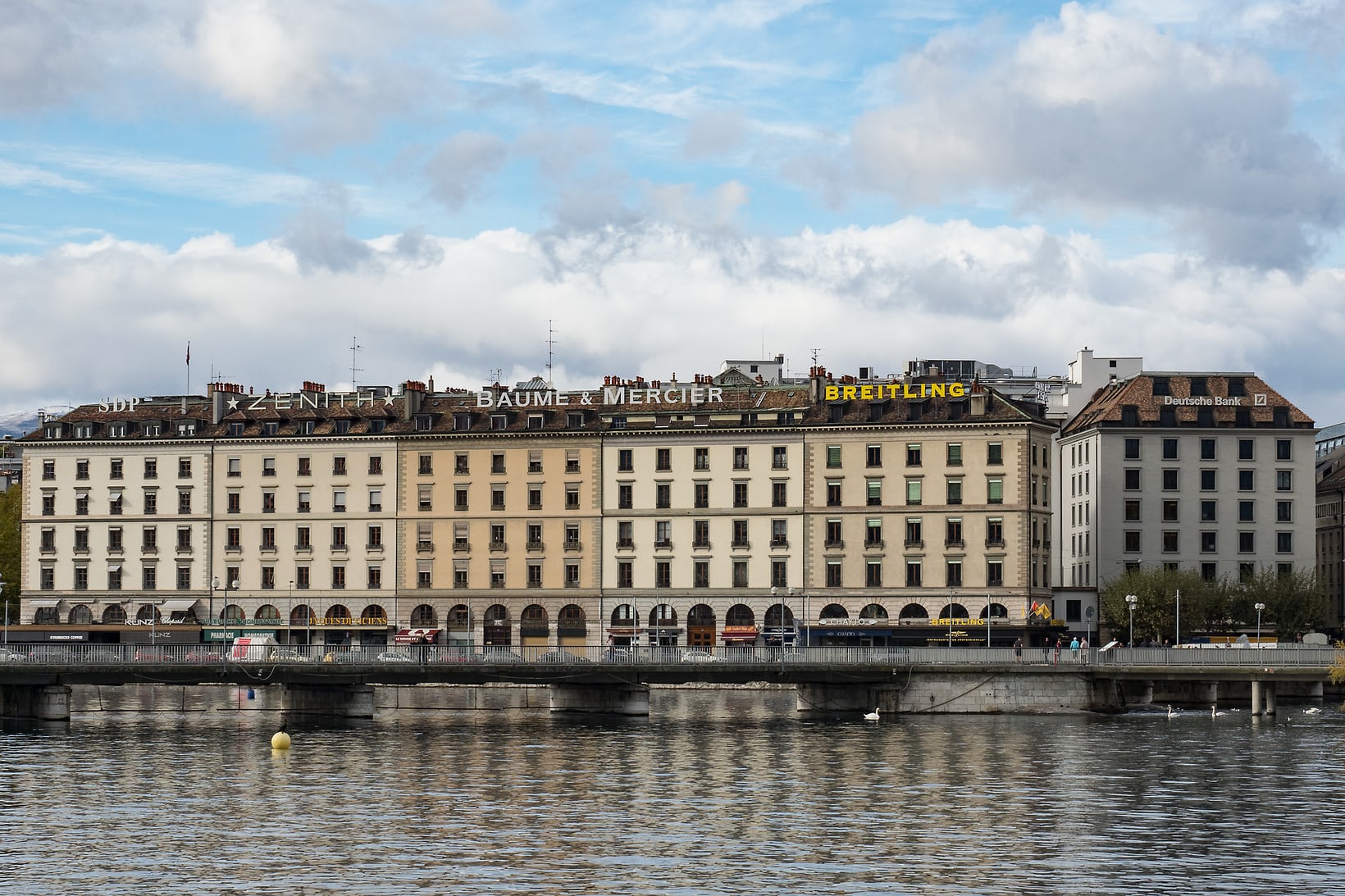 Downtown Geneva, showing brand signage on buildings overlooking the Rhône