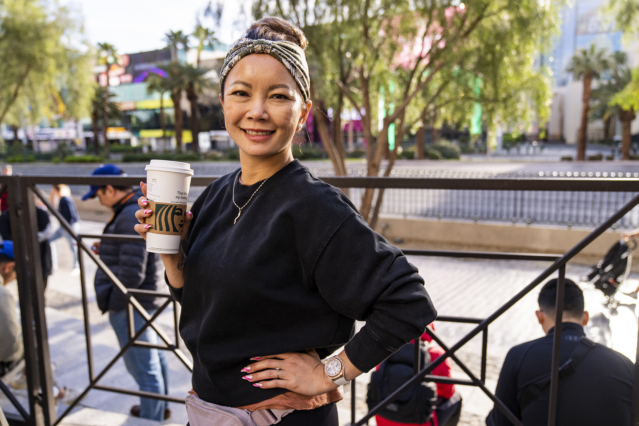 A woman poses while wearing a watch.