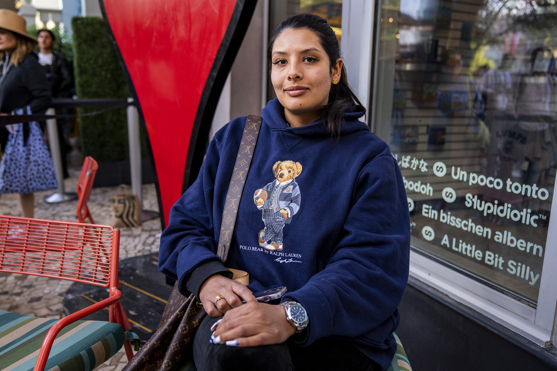 A woman poses while wearing a watch.