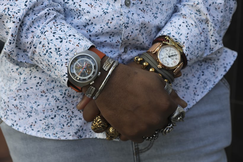 A man wears a watch on both wrists.