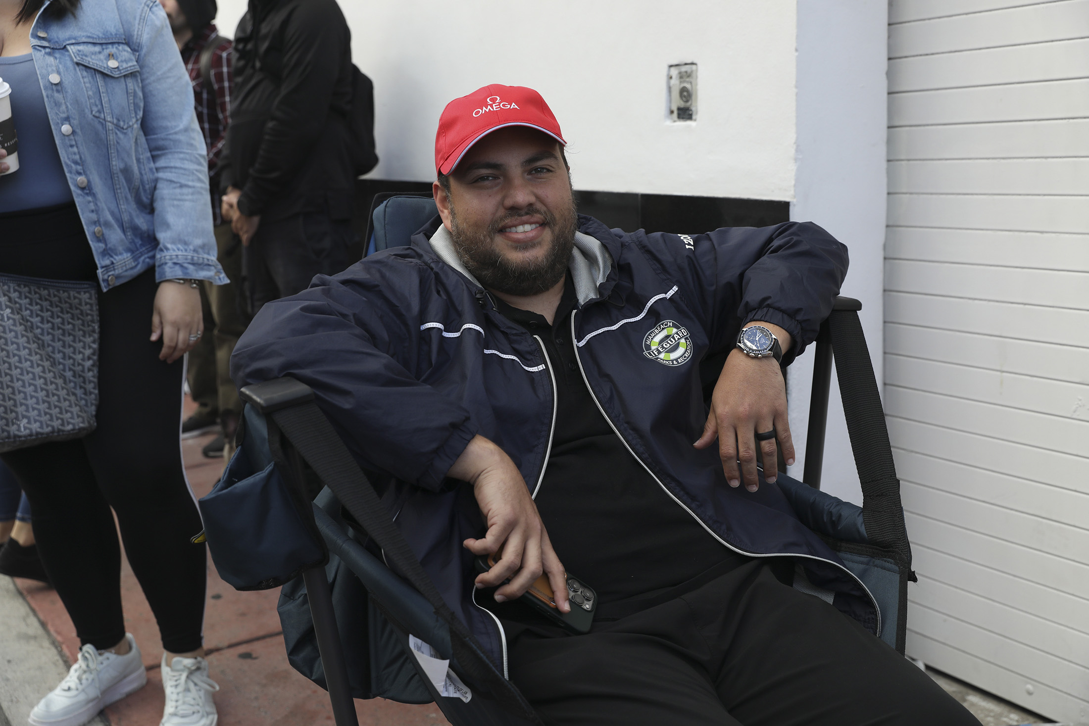 A man poses while wearing a watch.