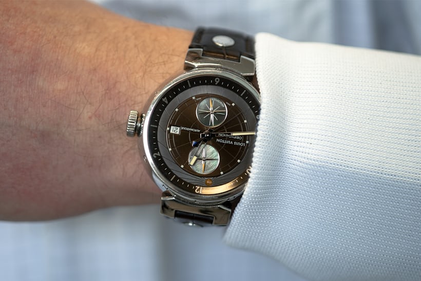 A man wears a Louis Vuitton wristwatch. 