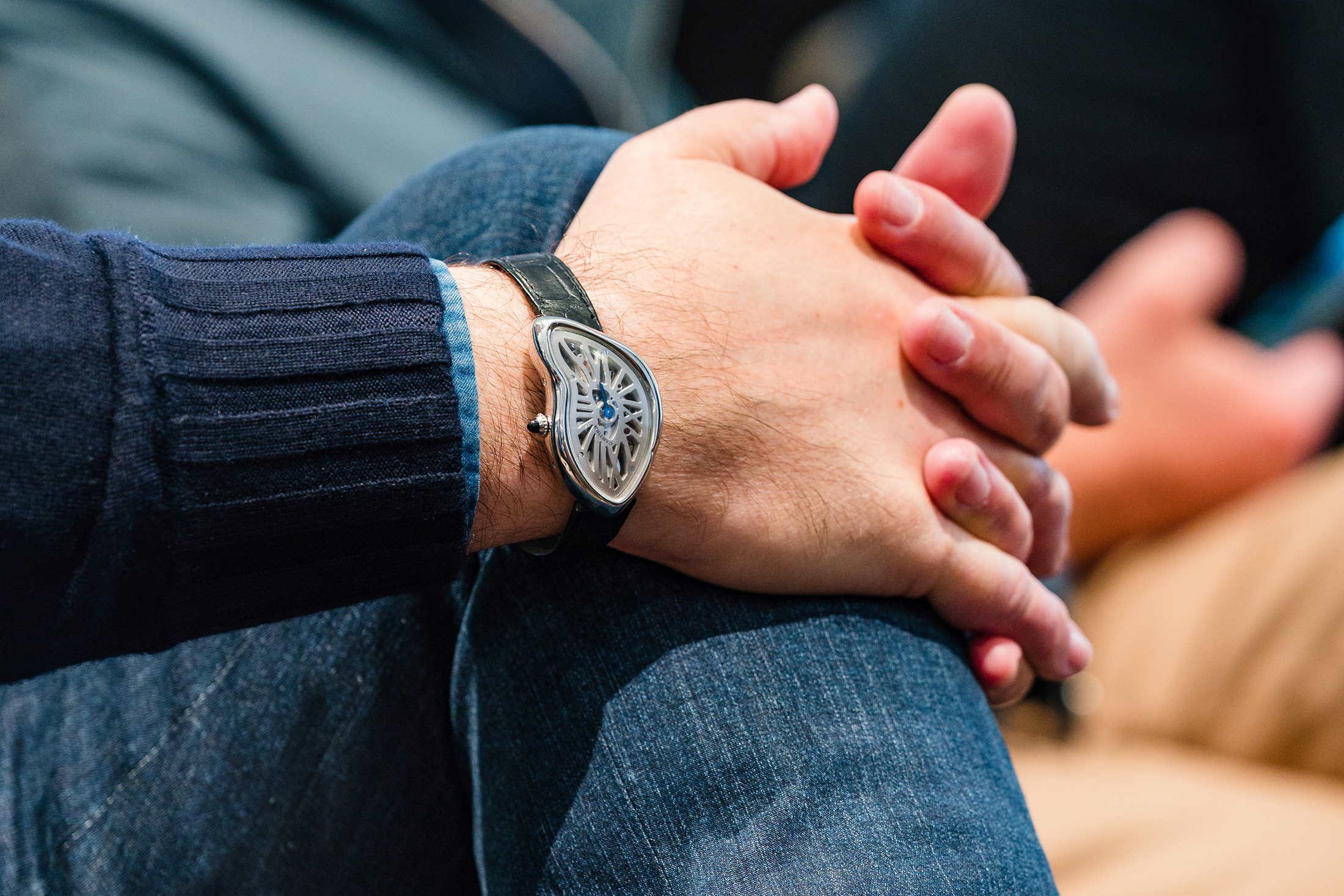 A man wears a Cartier Crash at Phillips. 