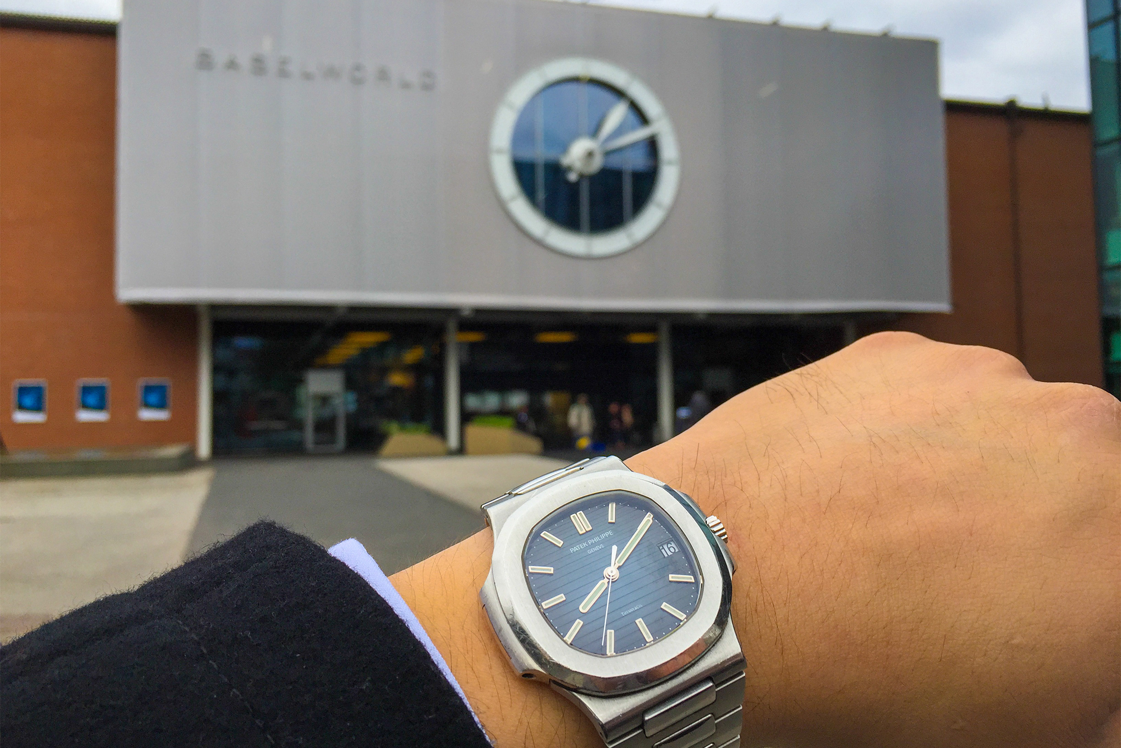 A man wears a Patek Philippe 5711 Nautilus with Tiffany stamp