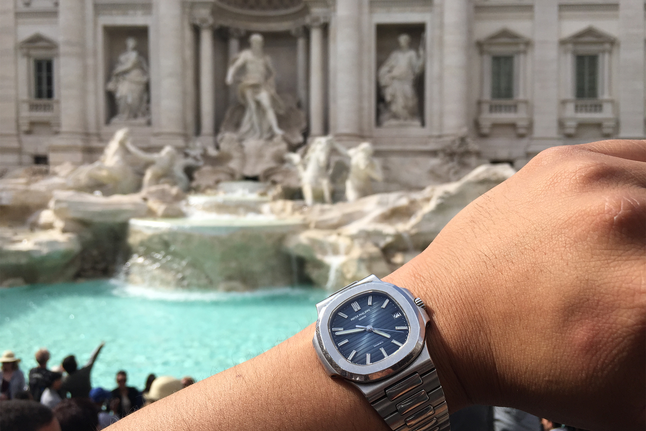 A man wears a Patek Philippe 5711 Nautilus with Tiffany stamp