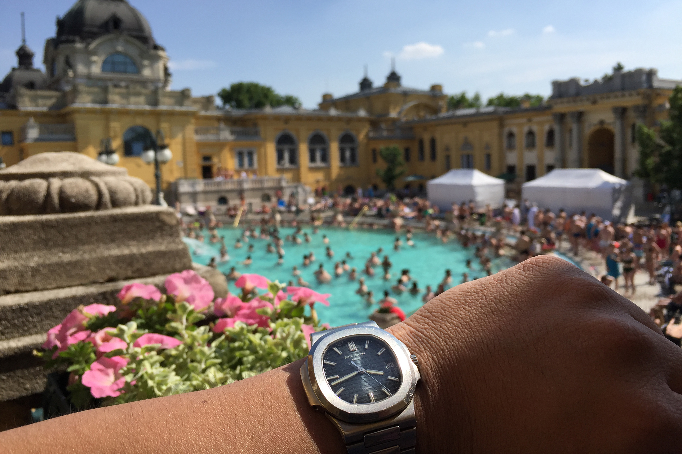 A man wears a Patek Philippe 5711 Nautilus with Tiffany stamp
