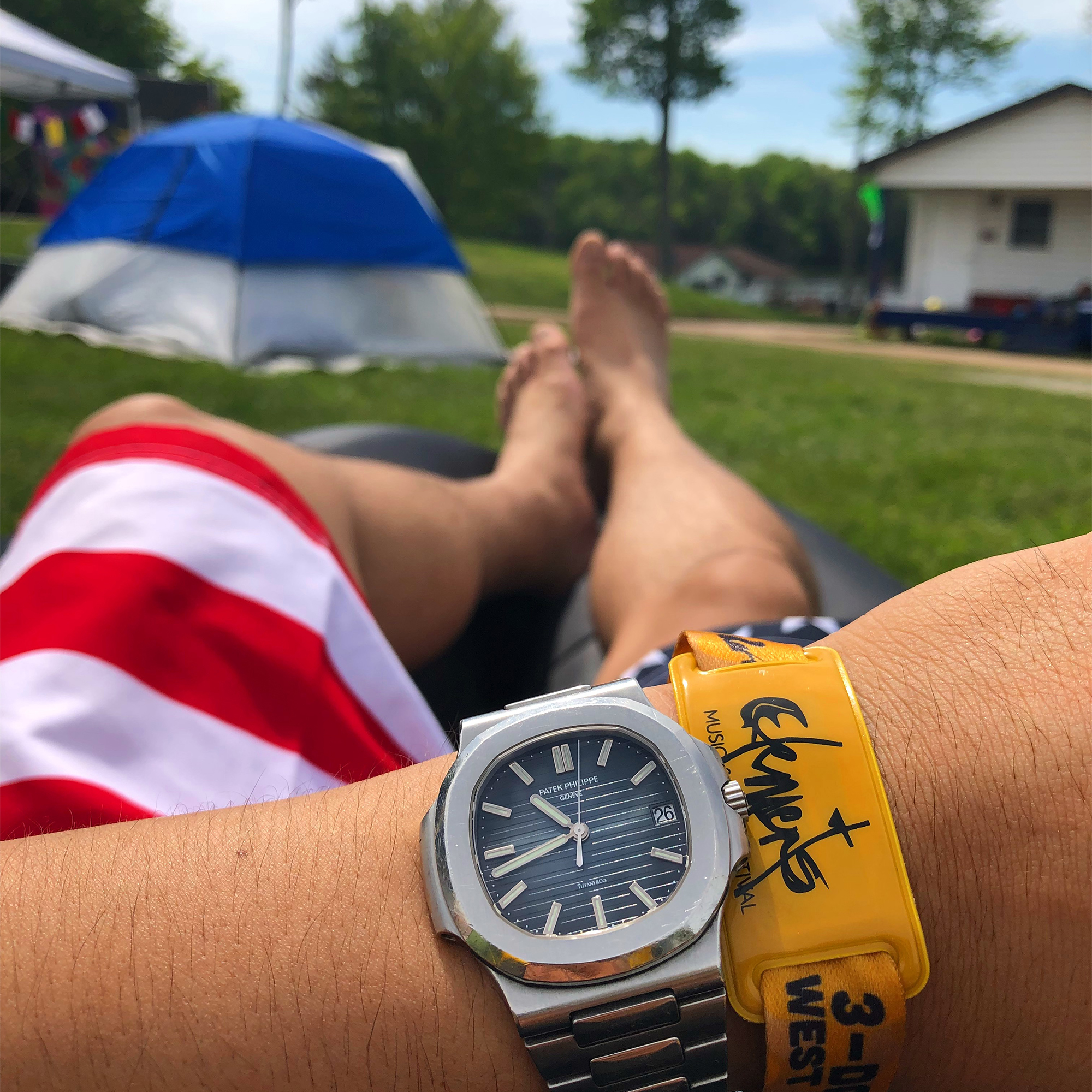 A man wears a Patek Philippe 5711 Nautilus with Tiffany stamp
