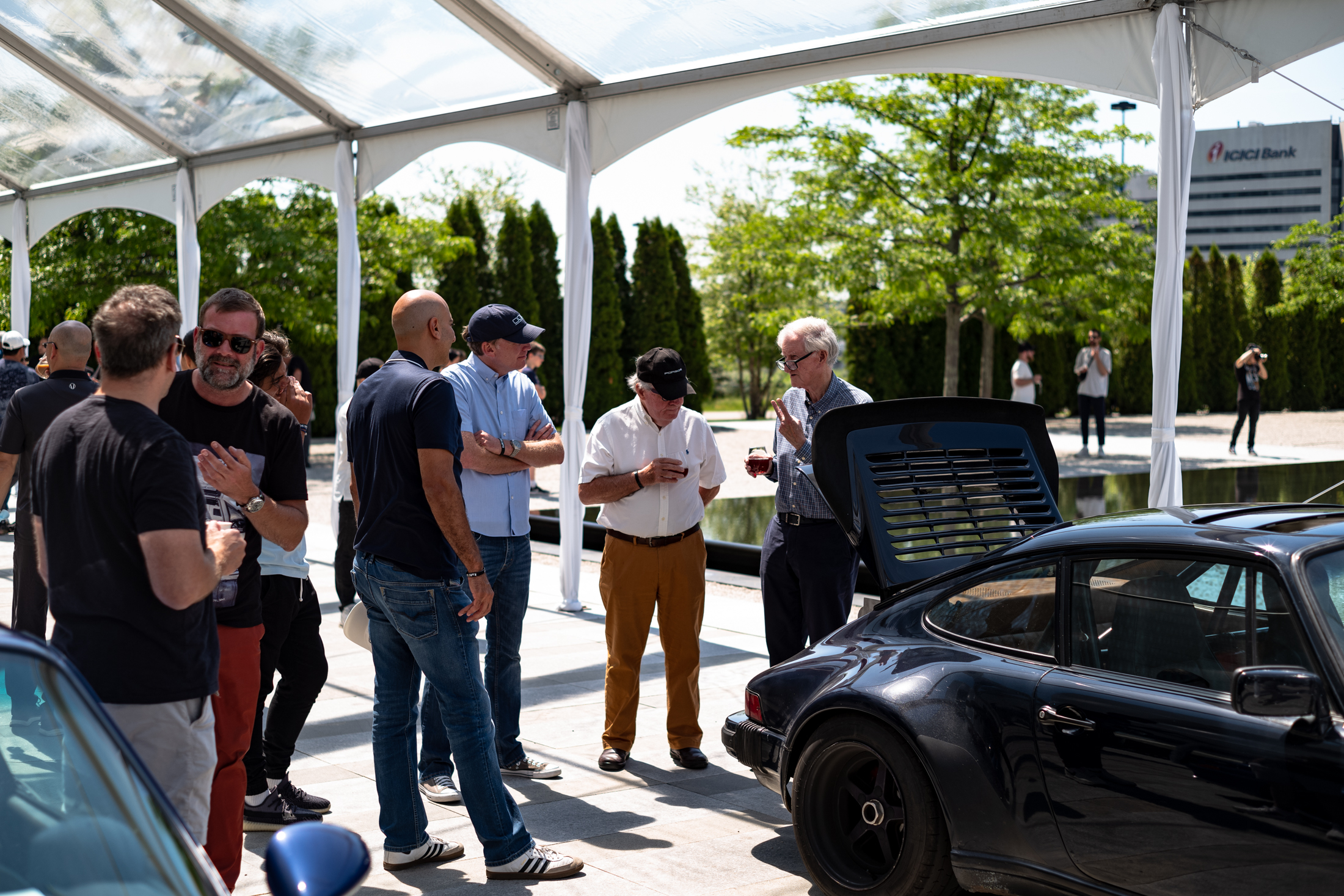people looking at a car