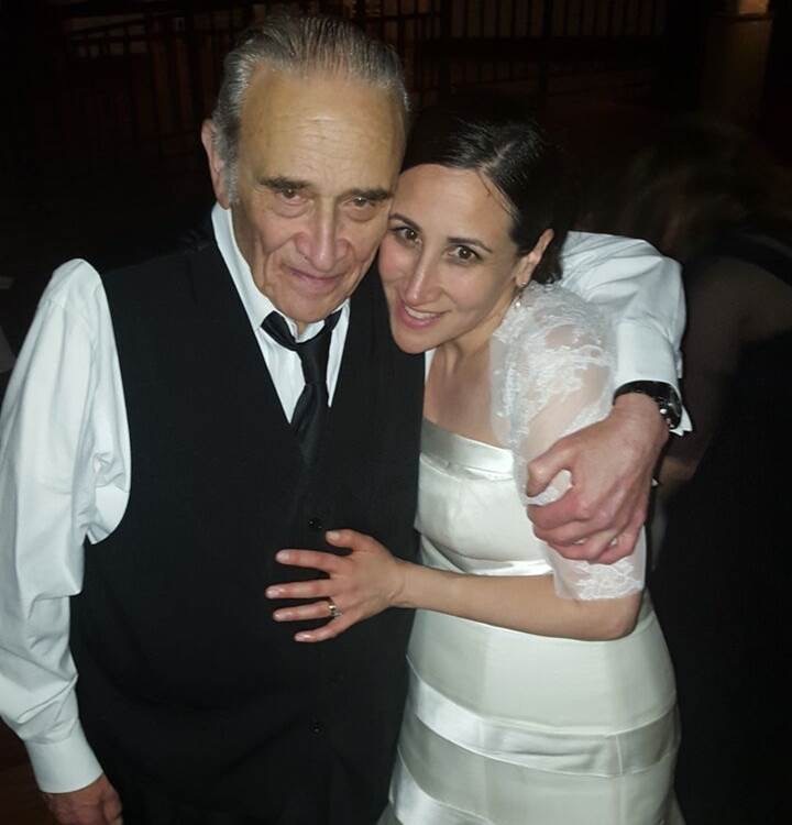 A woman and her father embrace