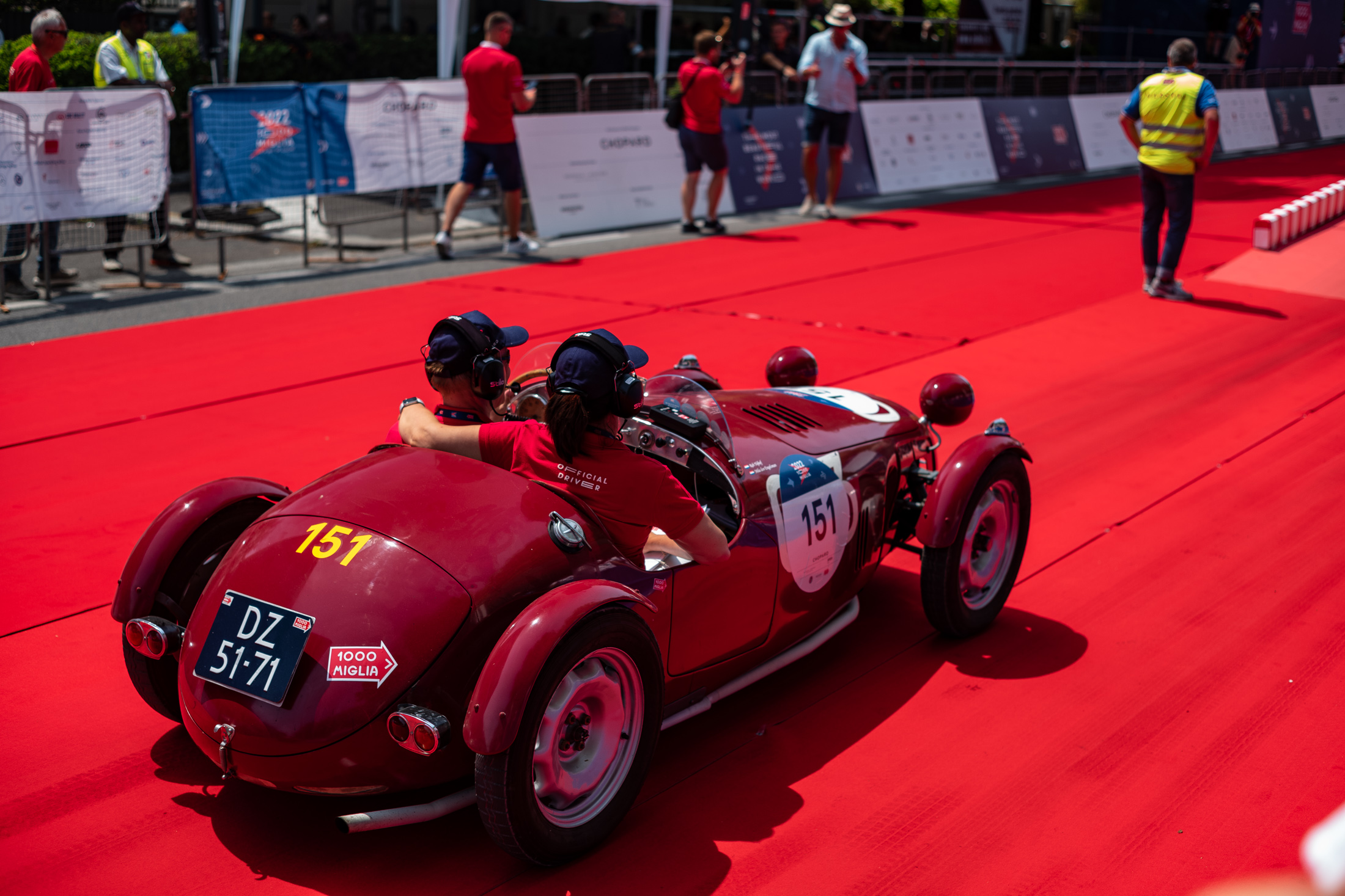 a pair sitting close in a red car