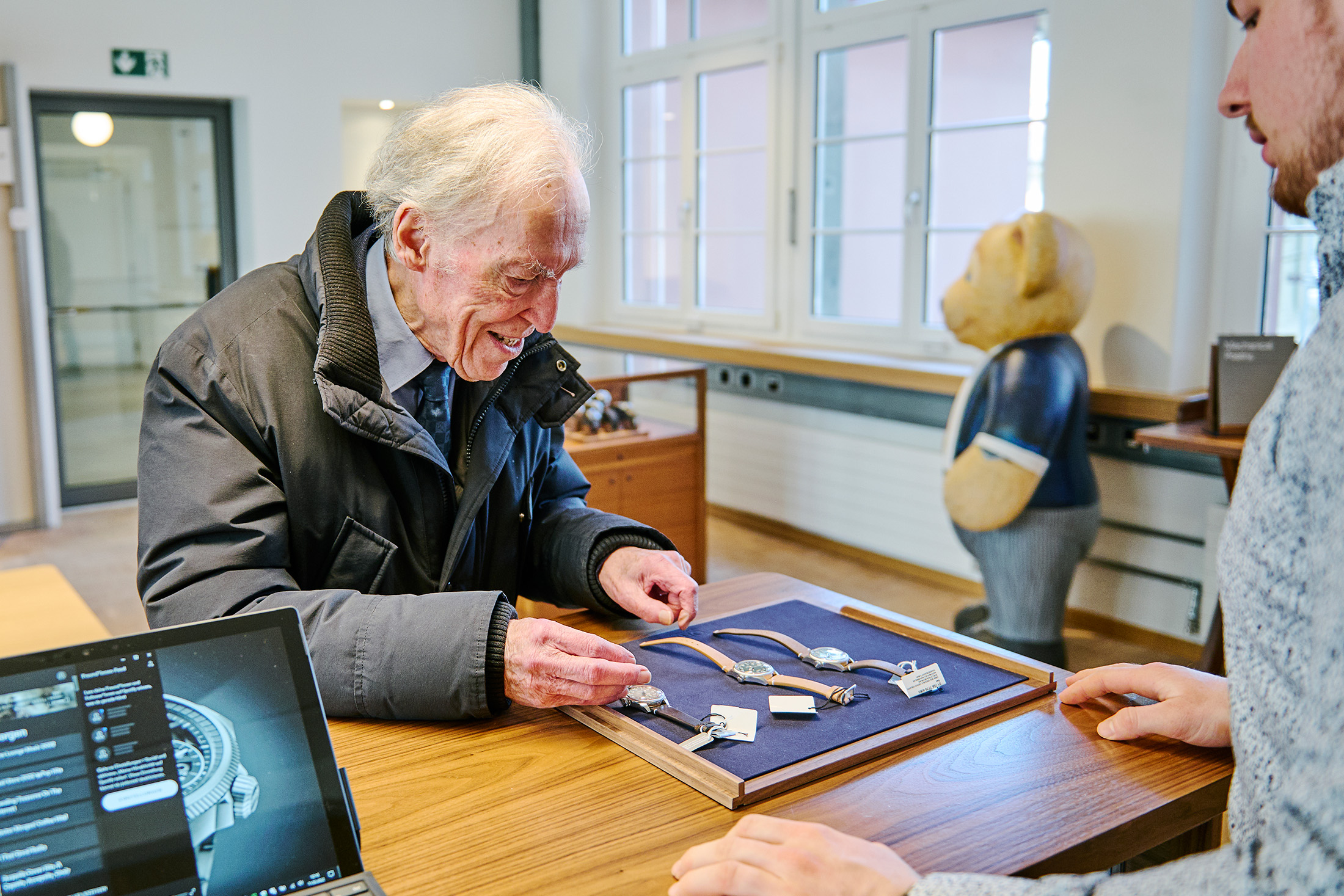 A man examines a tray of Oris watches