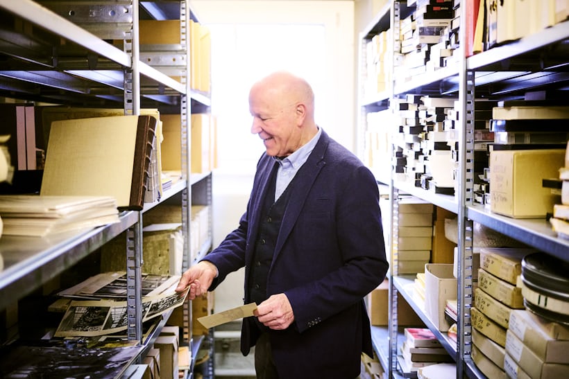 A man looks through the Oirs archive shelves 