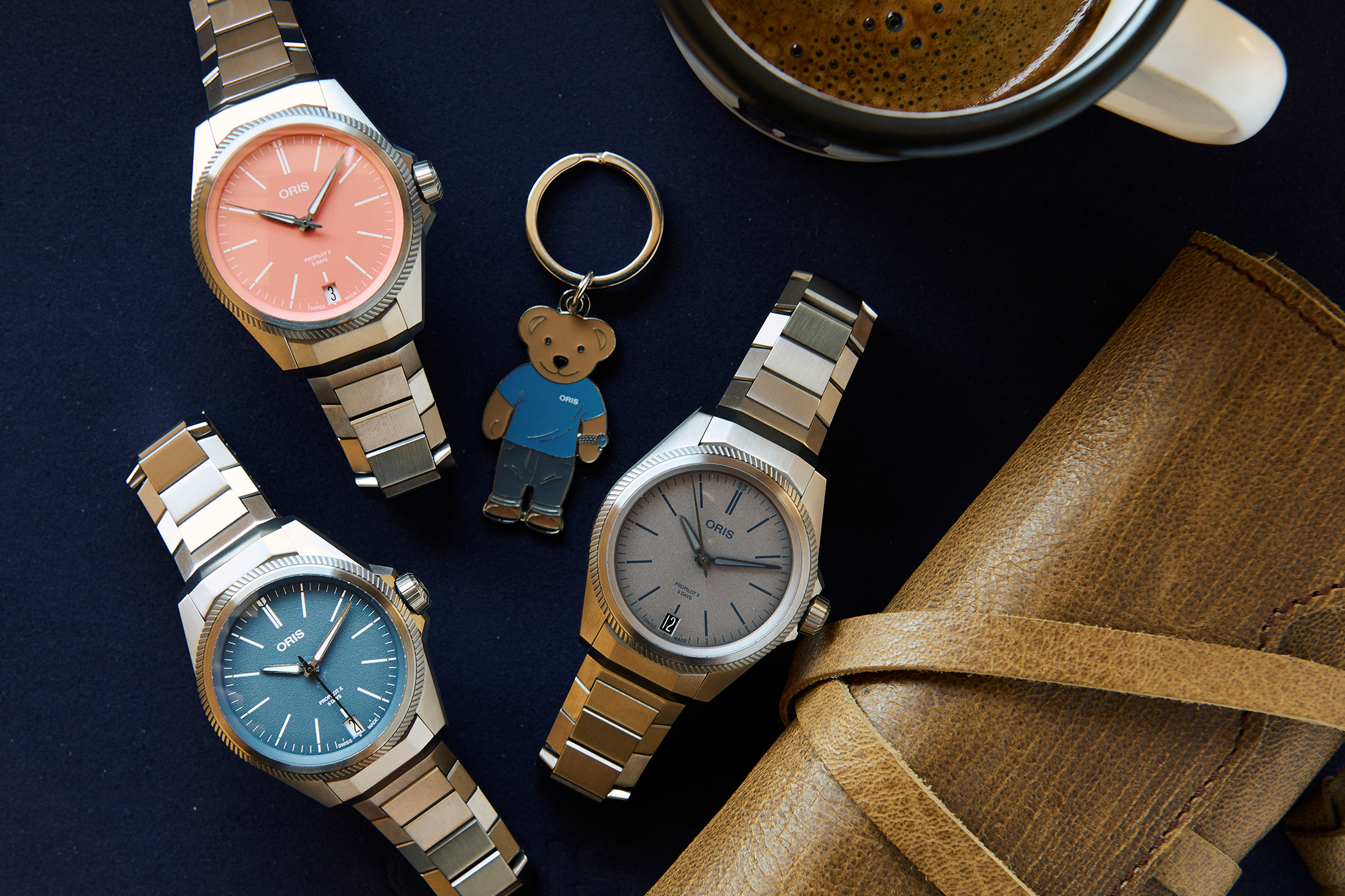 Three watches and an Oris bear keychain 