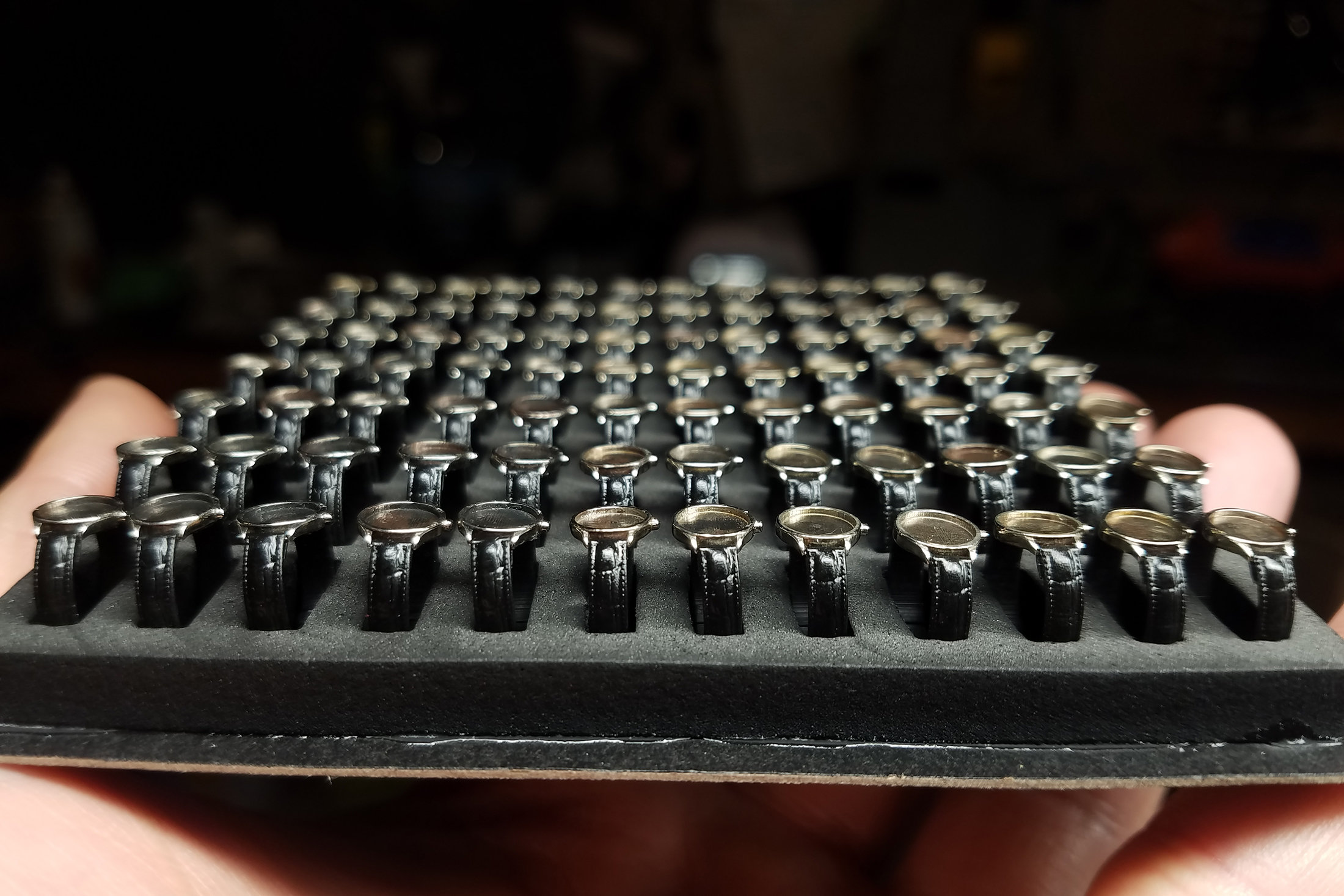 Tray of tiny Omega watch cases