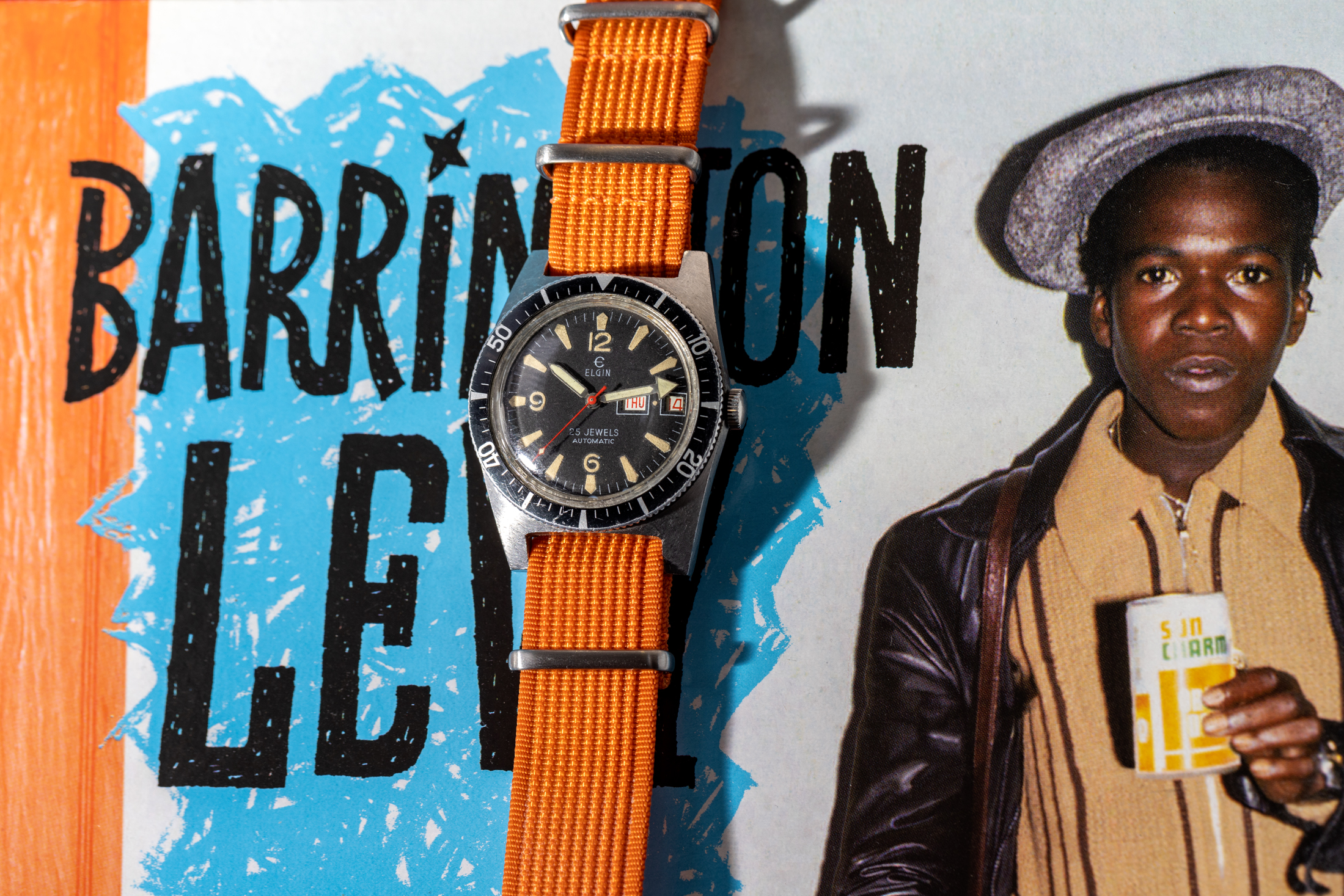 An Elgin Skin Diver watch on an orange strap