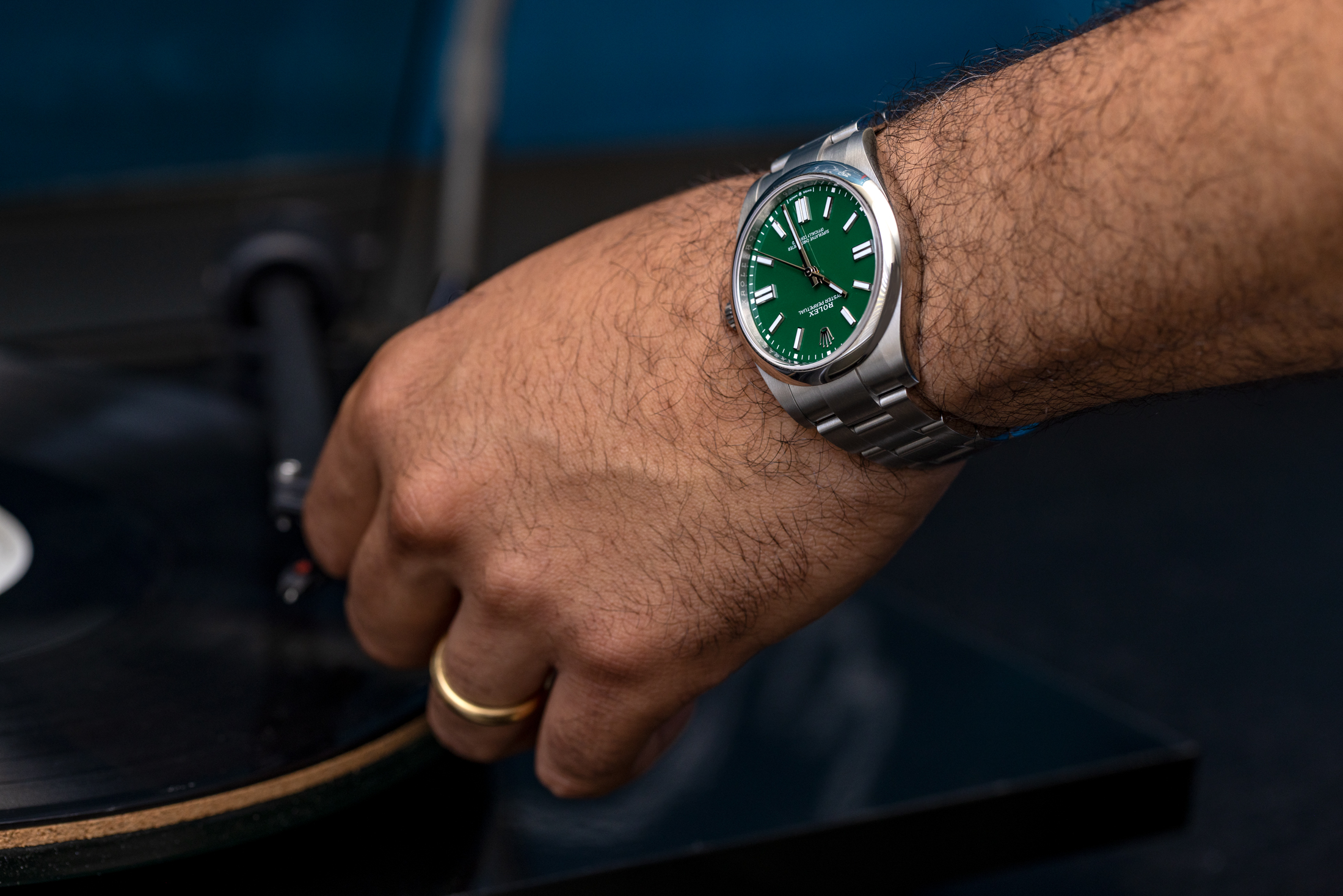 A man wearing a green dial rolex 