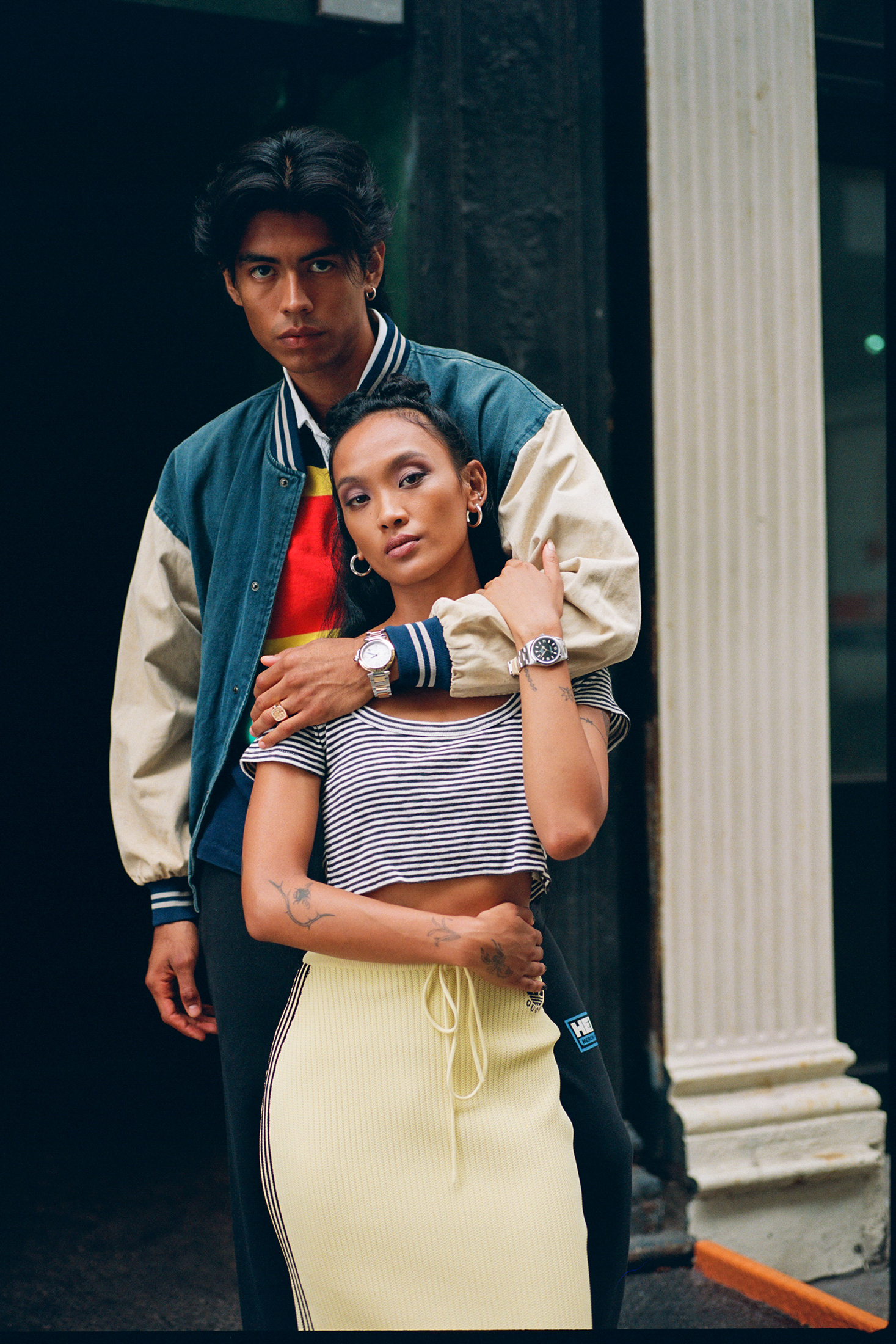 Two models posing on street.