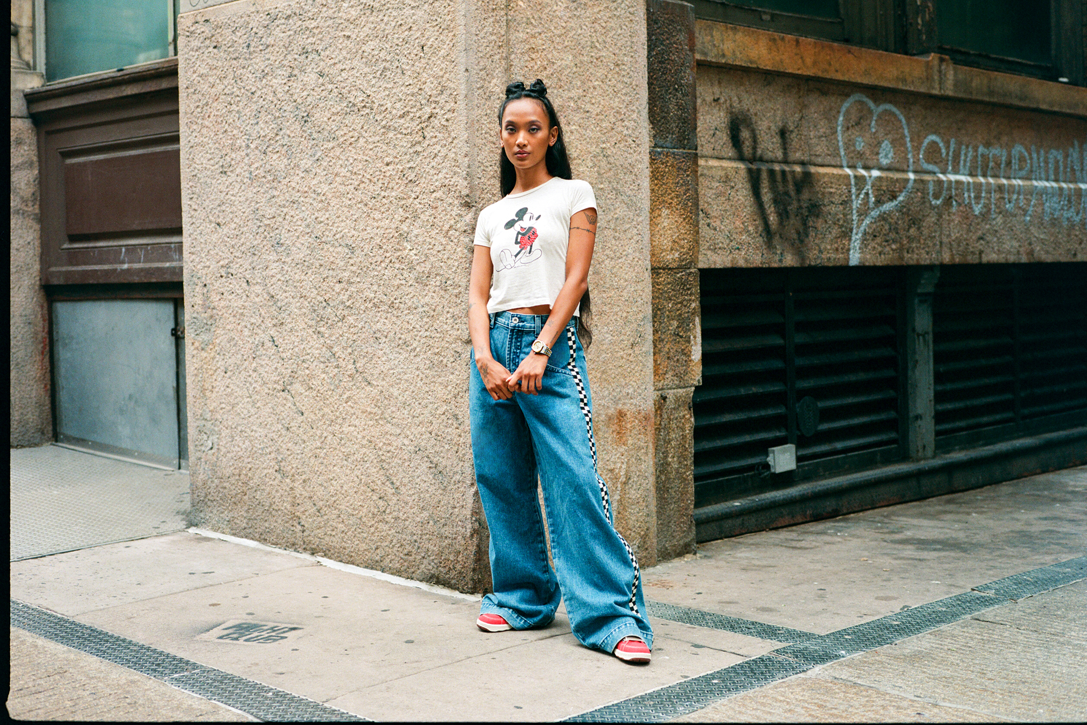 Model standing on corner.