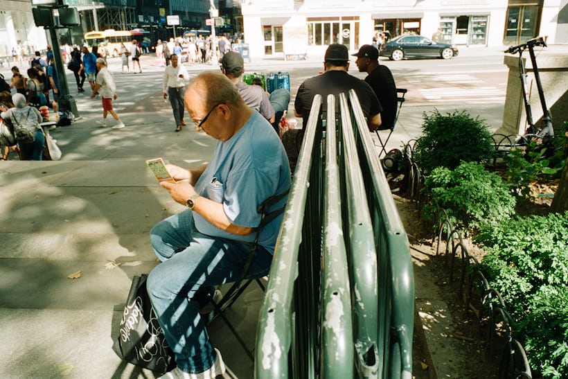 Man sitting on chair outside.