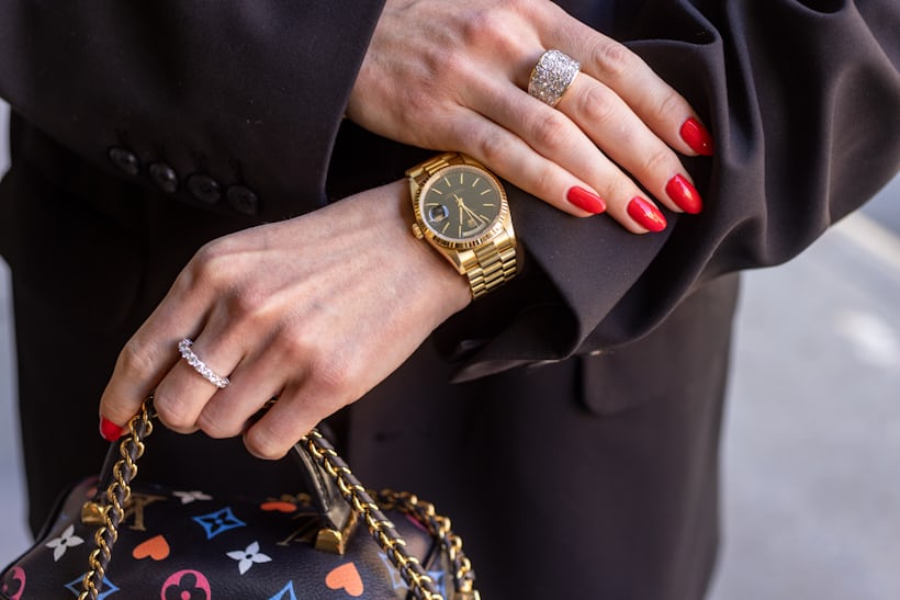 Wrist shot of Katrina wearing gold Rolex Day Date with a Jubilee bracelet. 