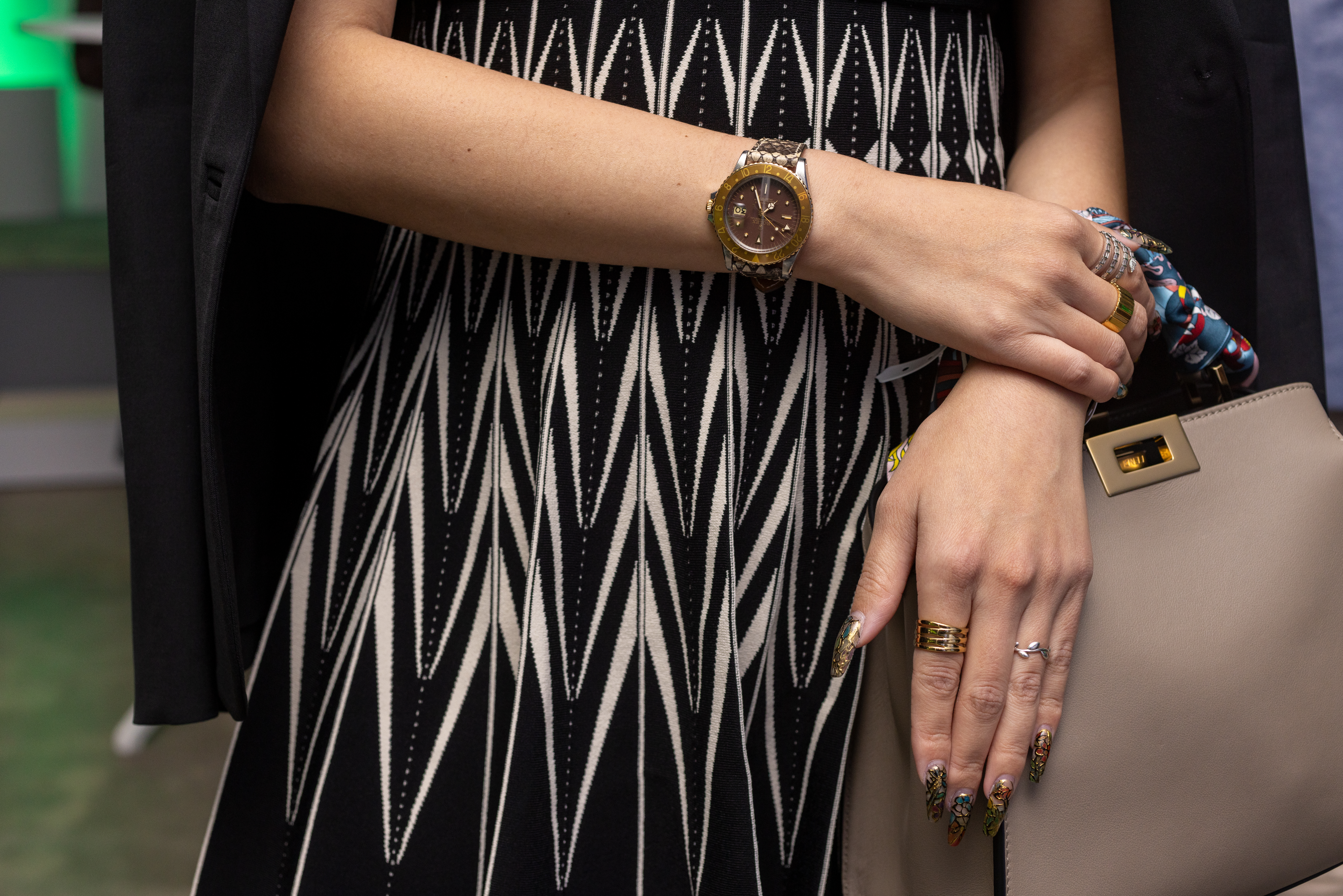 Rolex Oyster Perpetual pictured with pocketbook and scarf peaking. 
