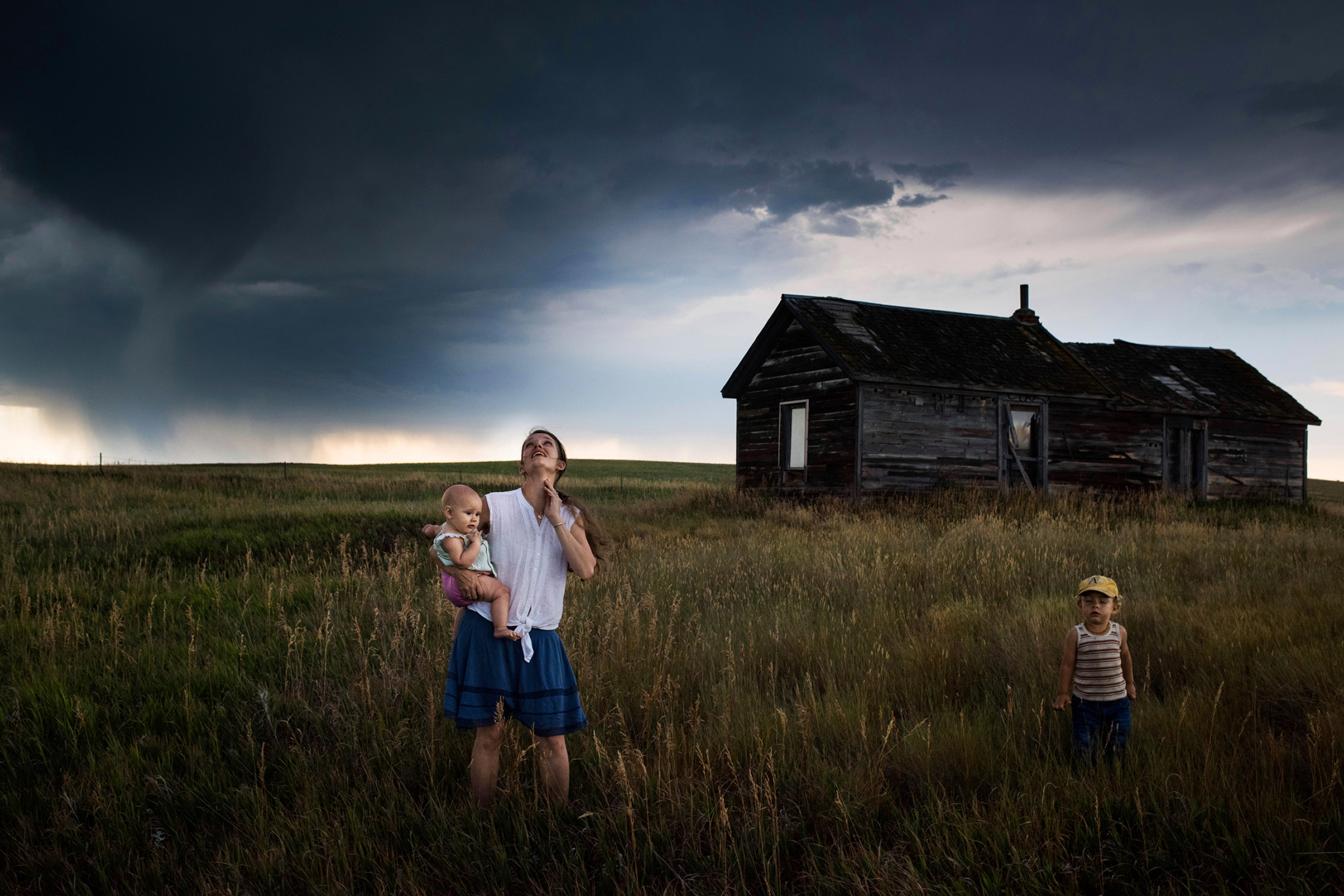 A photo of a woman and children in a field.