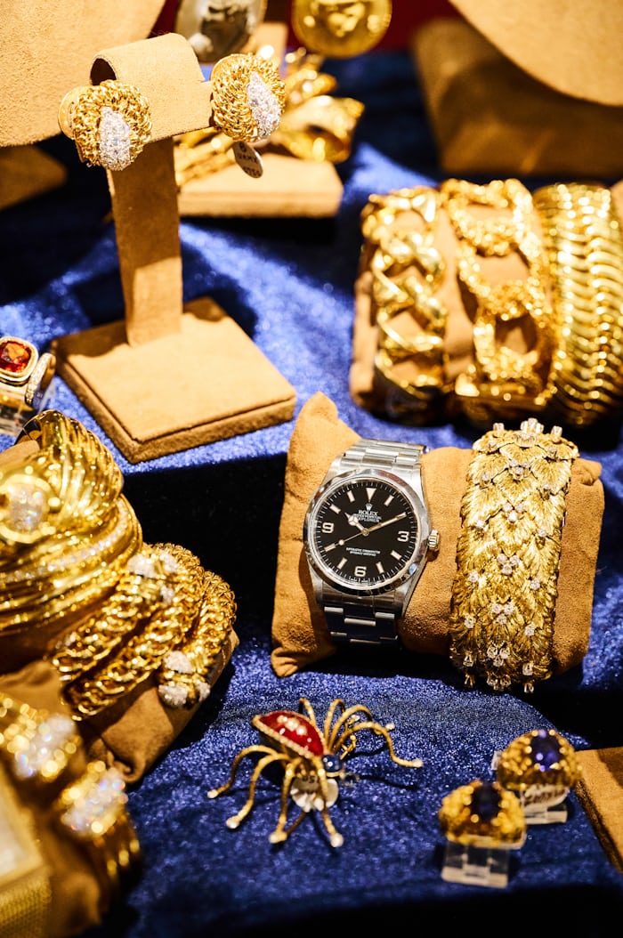Rolex Explorer surrounded by gold jewelry 