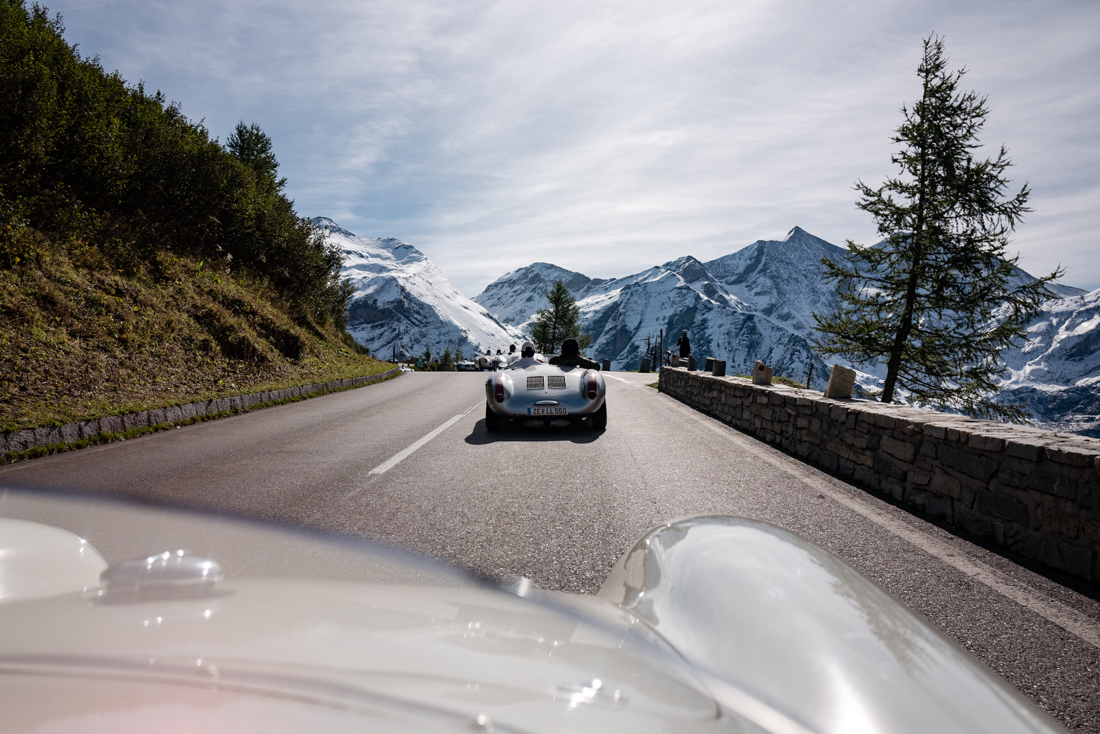 porsche 550s driving on a mountain road. 