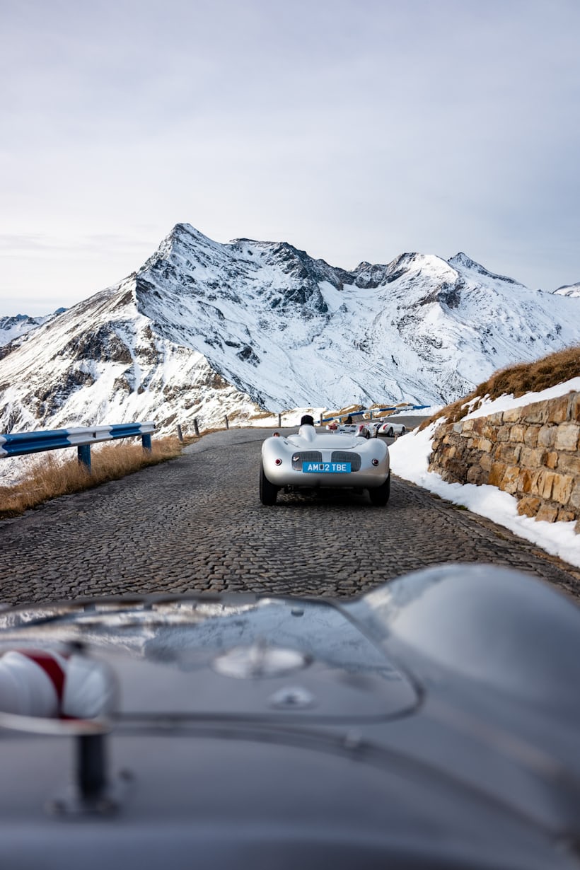 a series of vintage porsches on a road