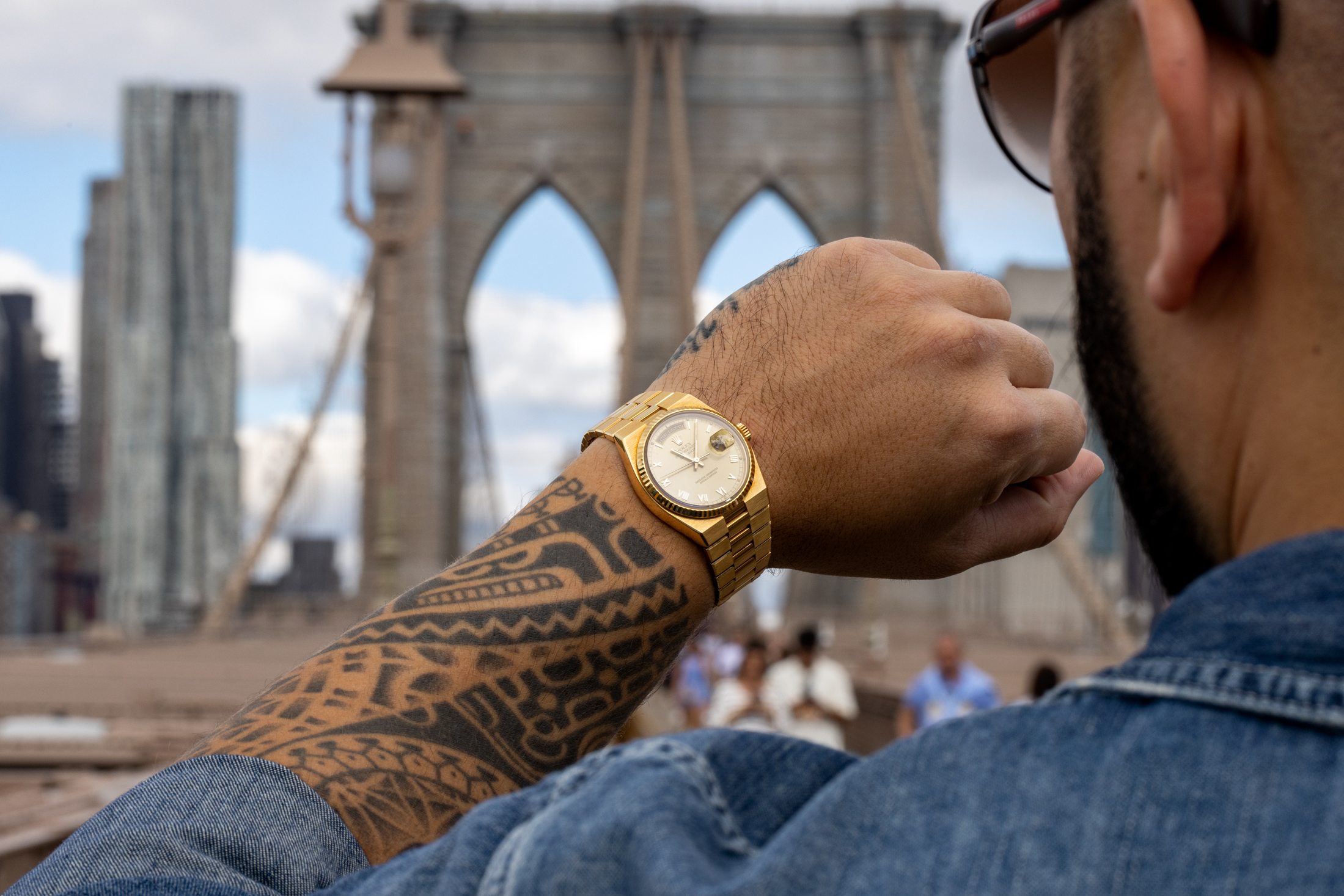 A man with a rolex on the brooklyn bridge