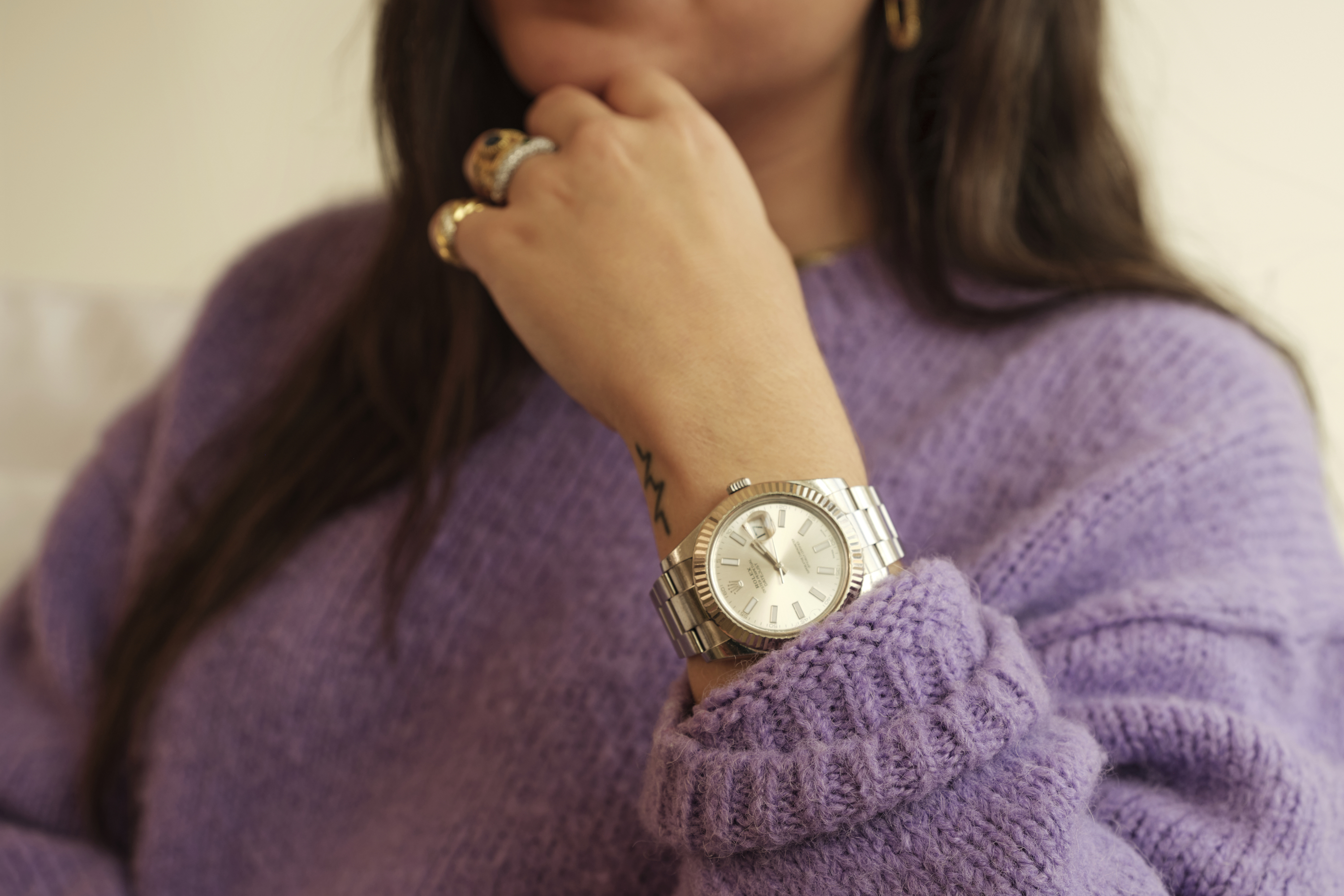 a rolex datejust on a woman's wrist