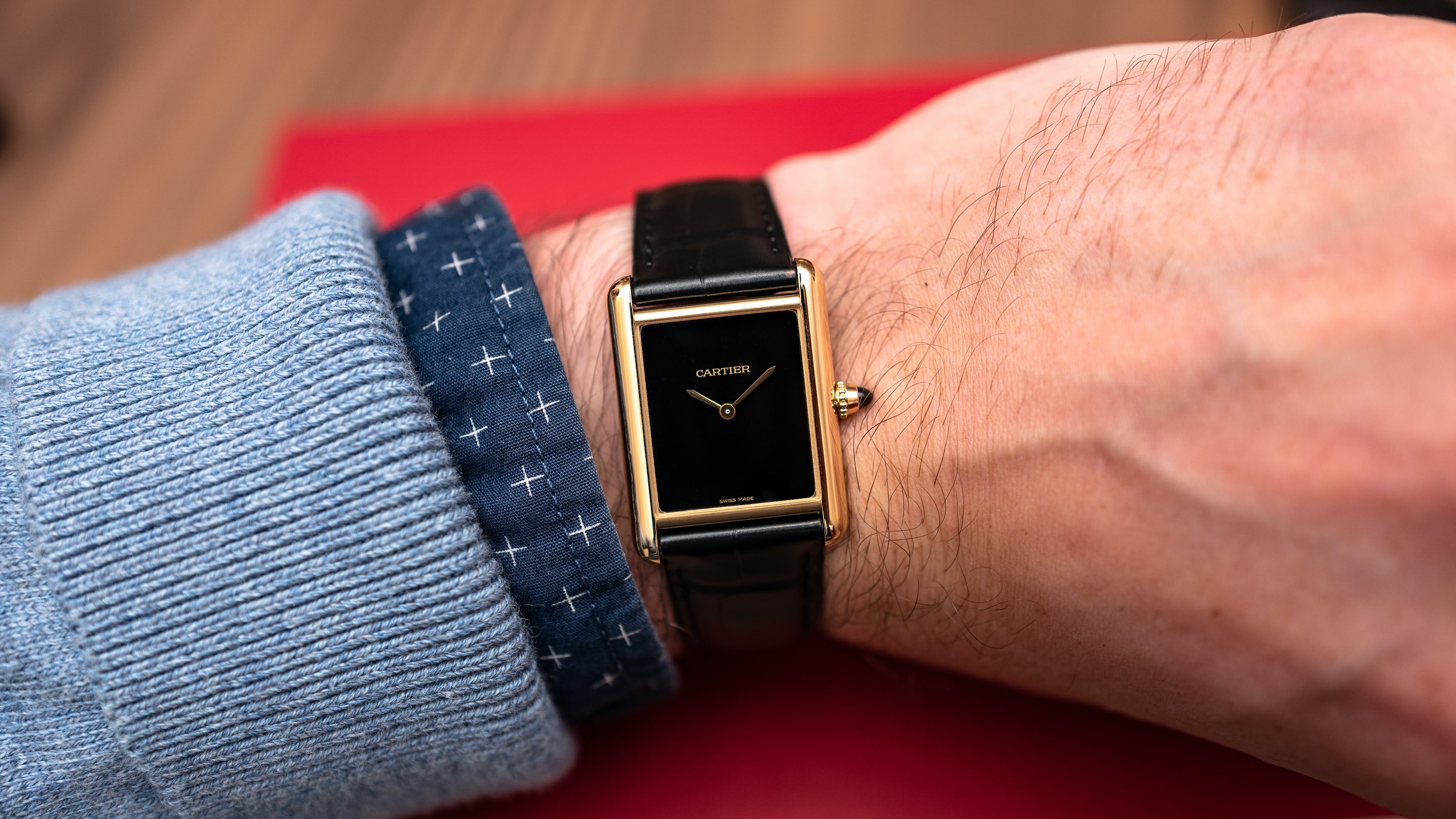 a cartier tank louis cartier on wrist. 