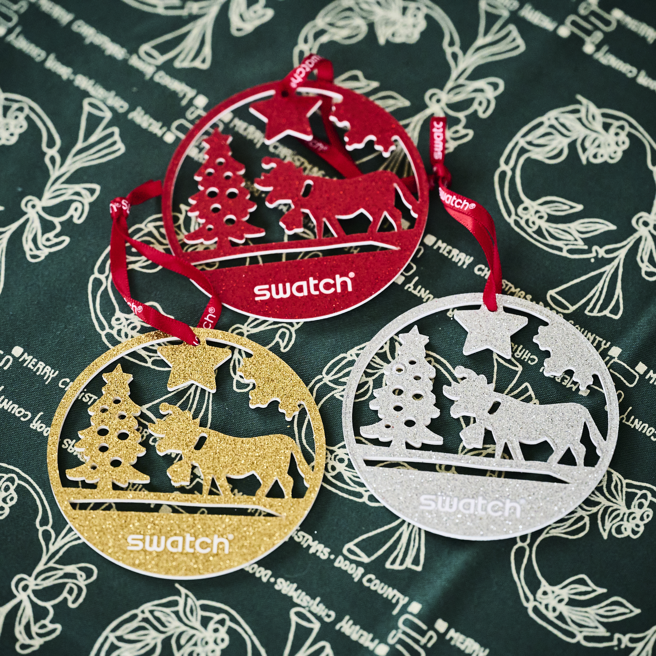 The ornaments with the The Swatch Golden Merry Christmas sweater watch.