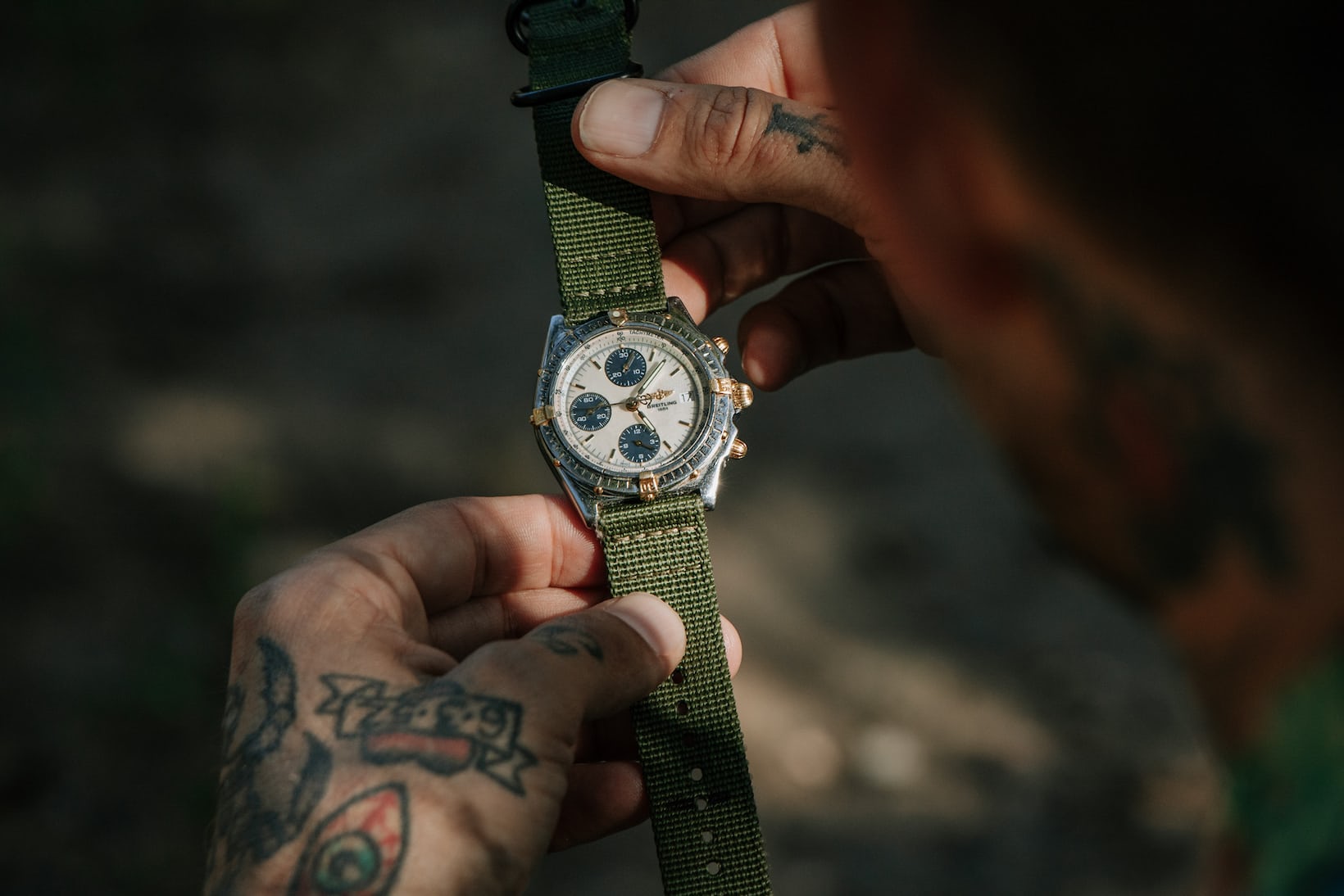 Person holding watch.