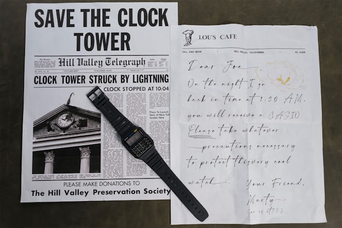 a watch and a handwritten note
