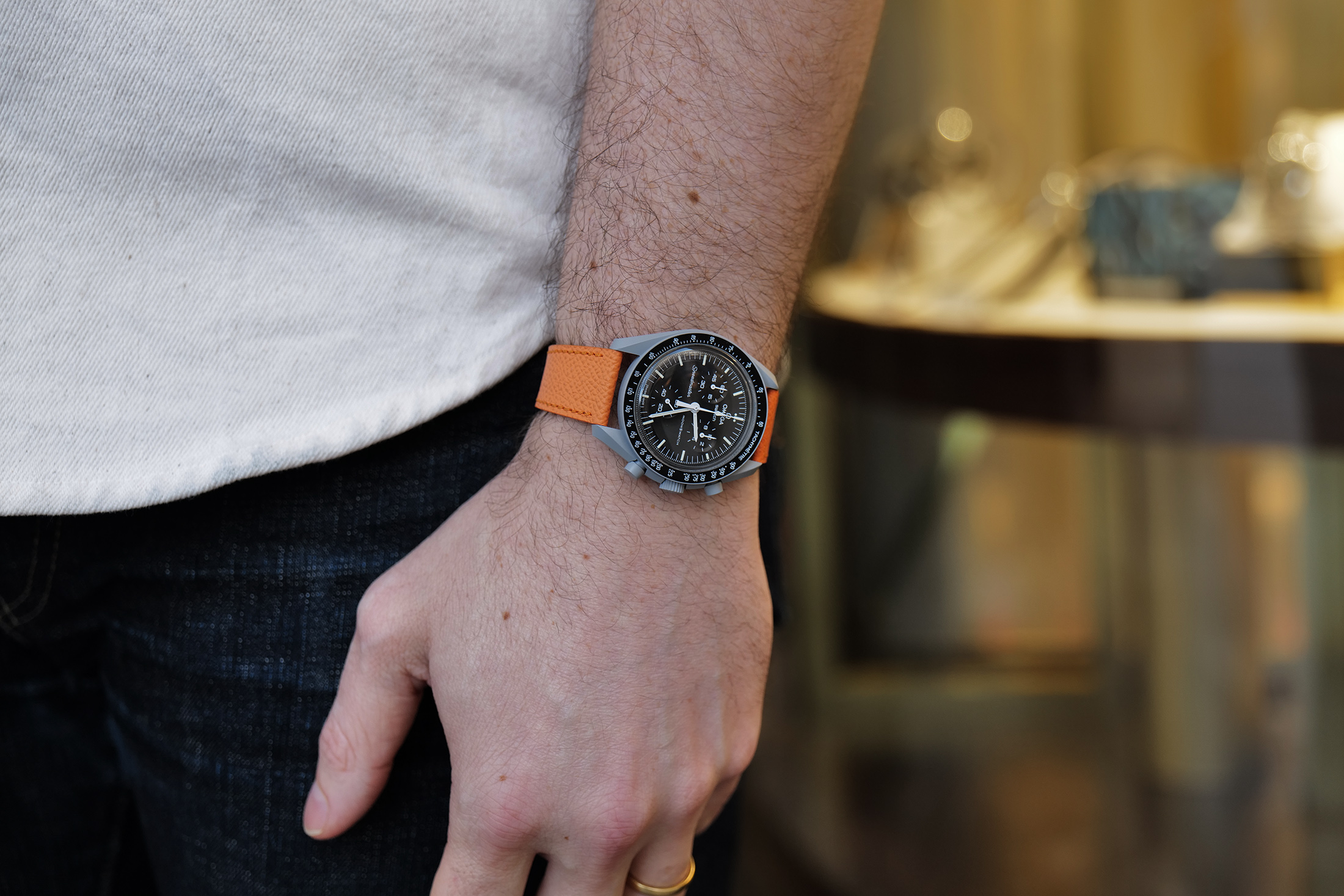 a person wears a MoonSwatch mission to the moon wrist watch