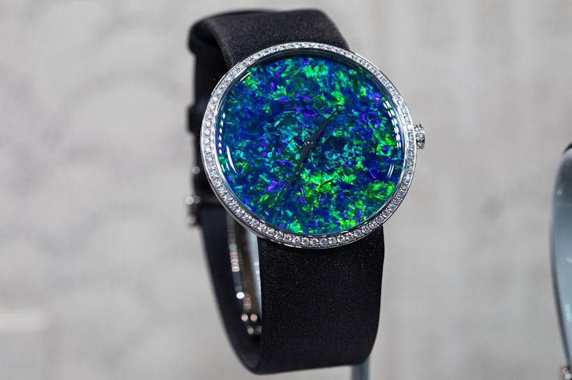 A watch with an opal dial