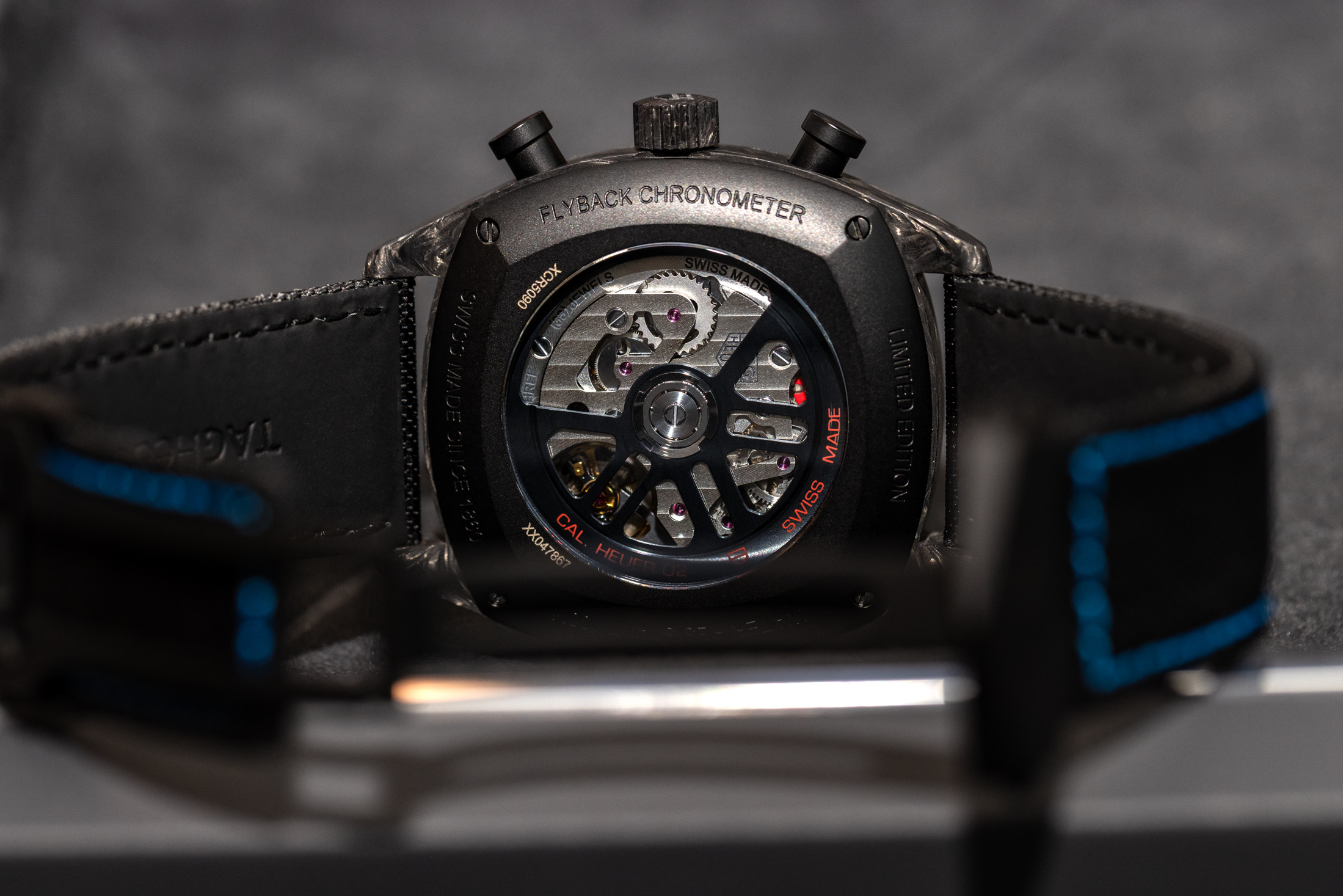 The TAG Heuer Monza's Calibre 02 movement with black rotor seen through a display caseback.