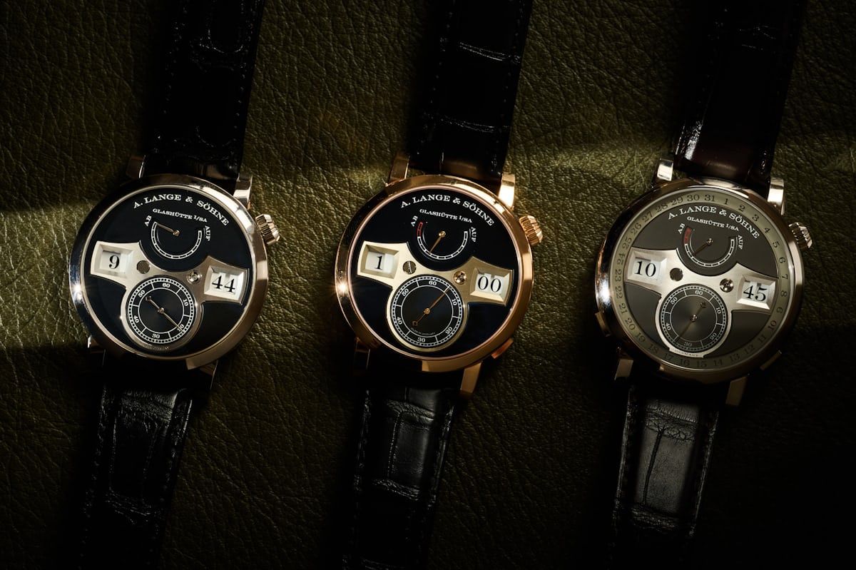 Three different Lange Zeitwerk watches laying on a table