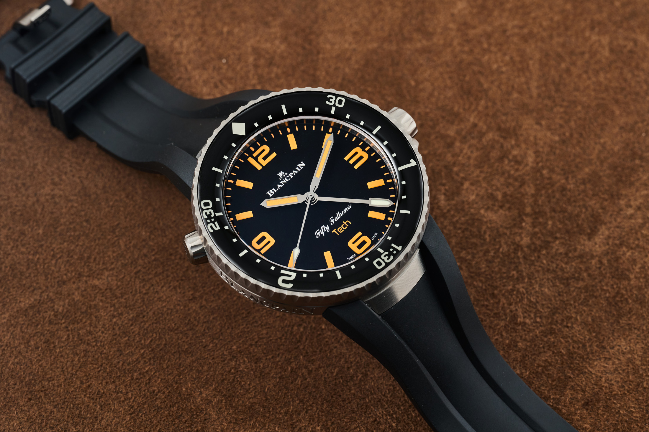 A Blancpain dive watch laying on a table face up