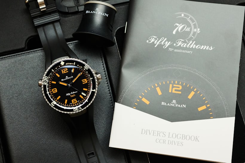 The dive book, loupe, and other items included with the Blancpain Fifty Fathoms Tech Gombessa watch