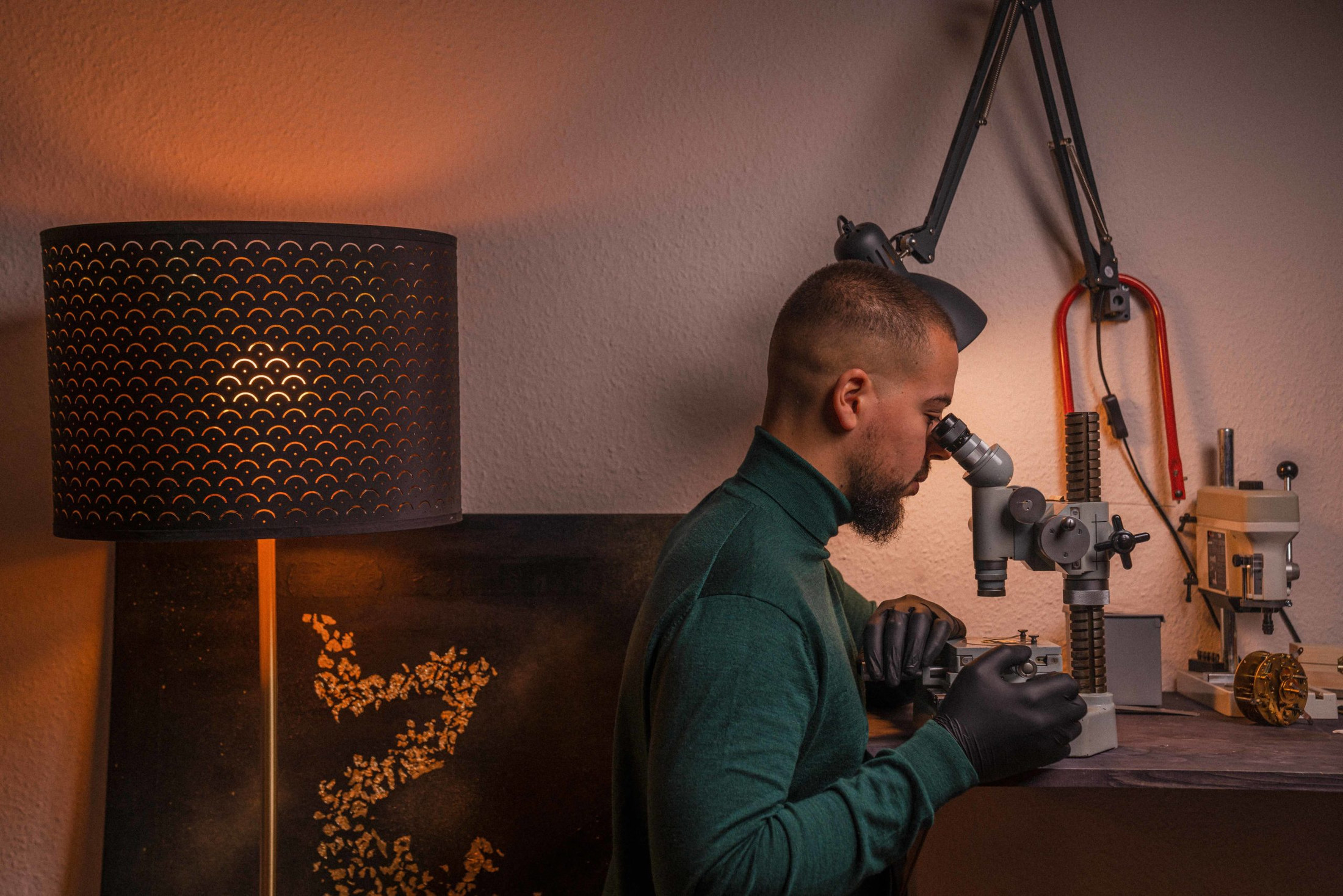 Felipe Pikullik working at a watchmaking bench in his workshop
