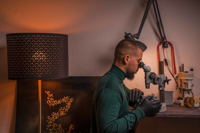 Felipe Pikullik working at a watchmaking bench in his workshop