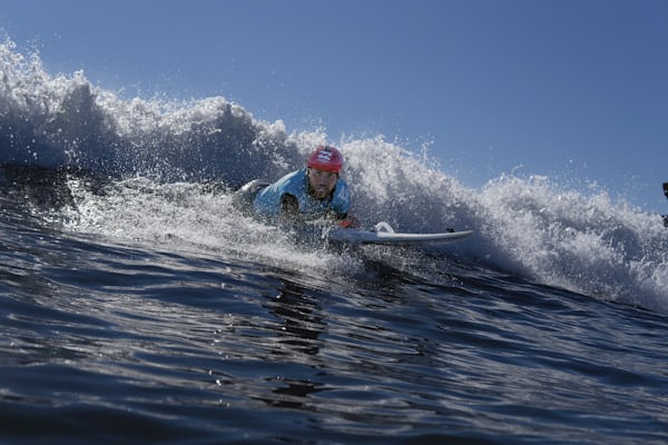 A person surfing as a part of the One More Wave group