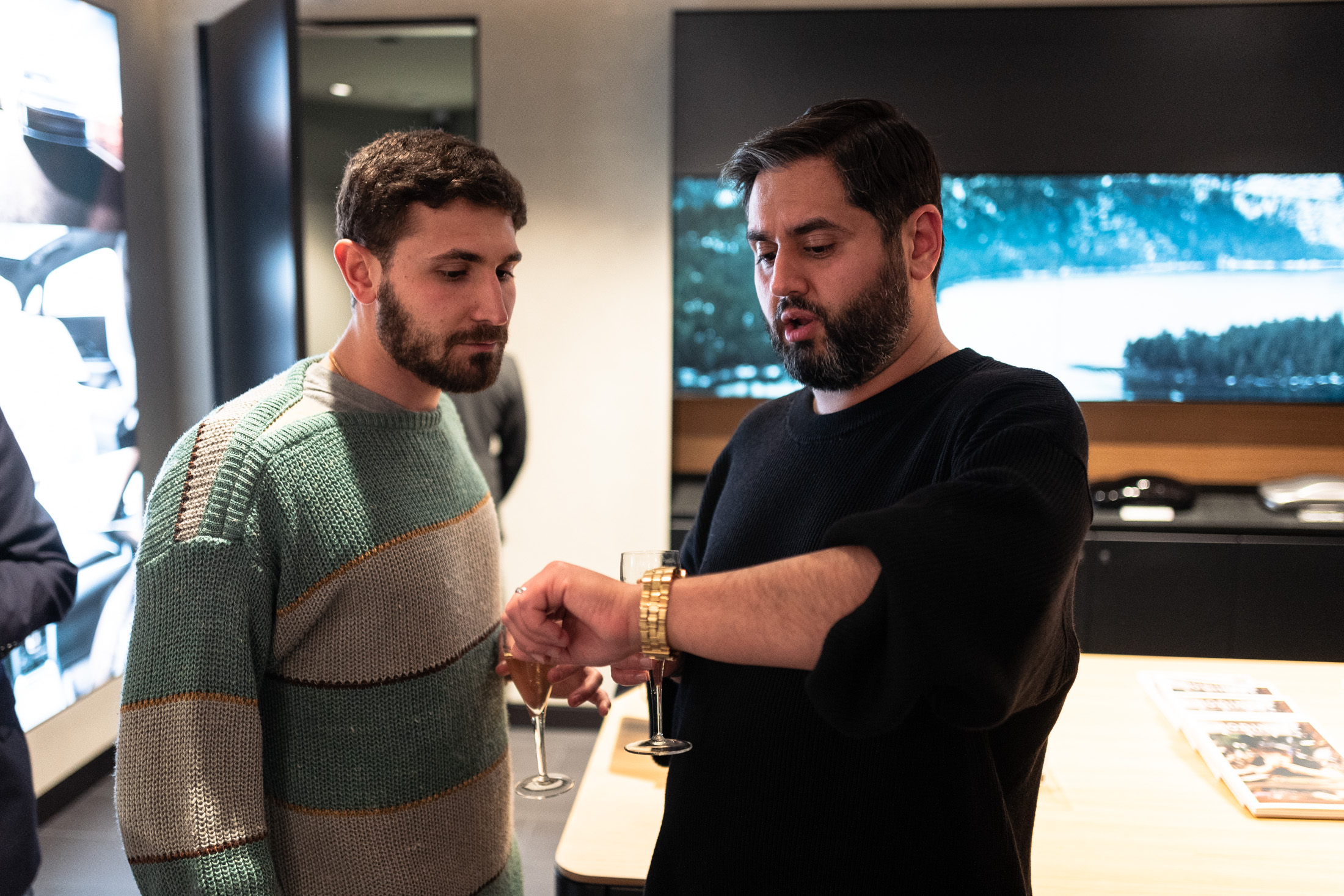 two men looking at a watch